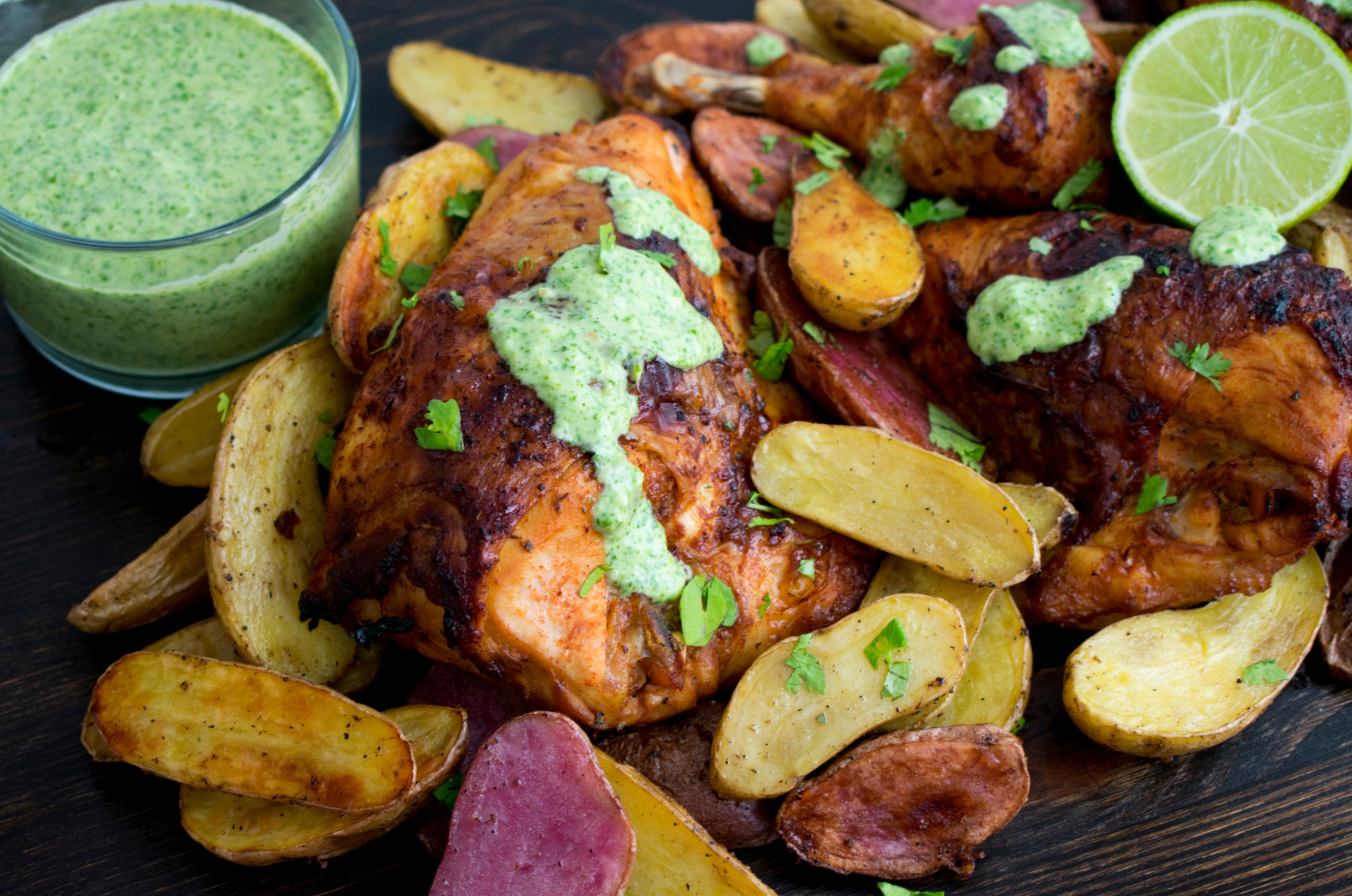 Image of Pro Chefly Peruvian chicken with green sauce, roasted baby potatoes, fresh lime, and parsley.