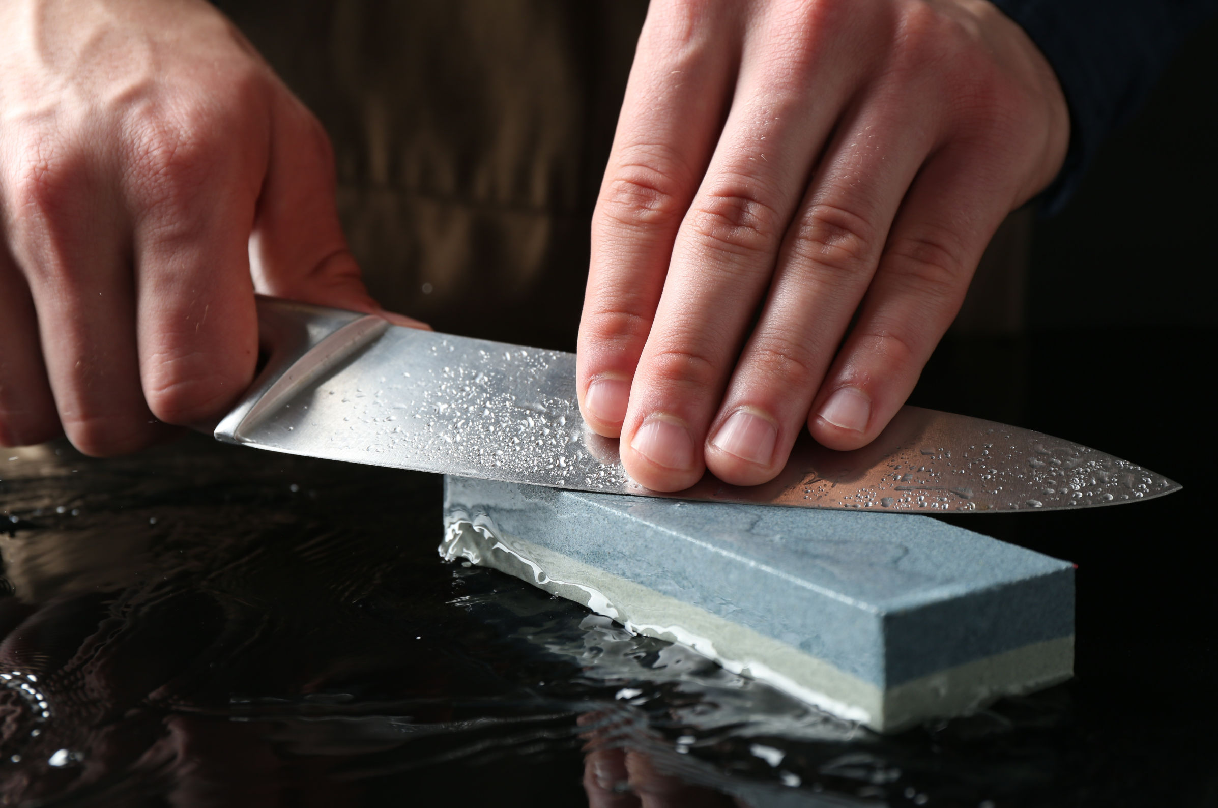 Image of Pro Chefly Damascus chef knife sharpened by a wet stone.