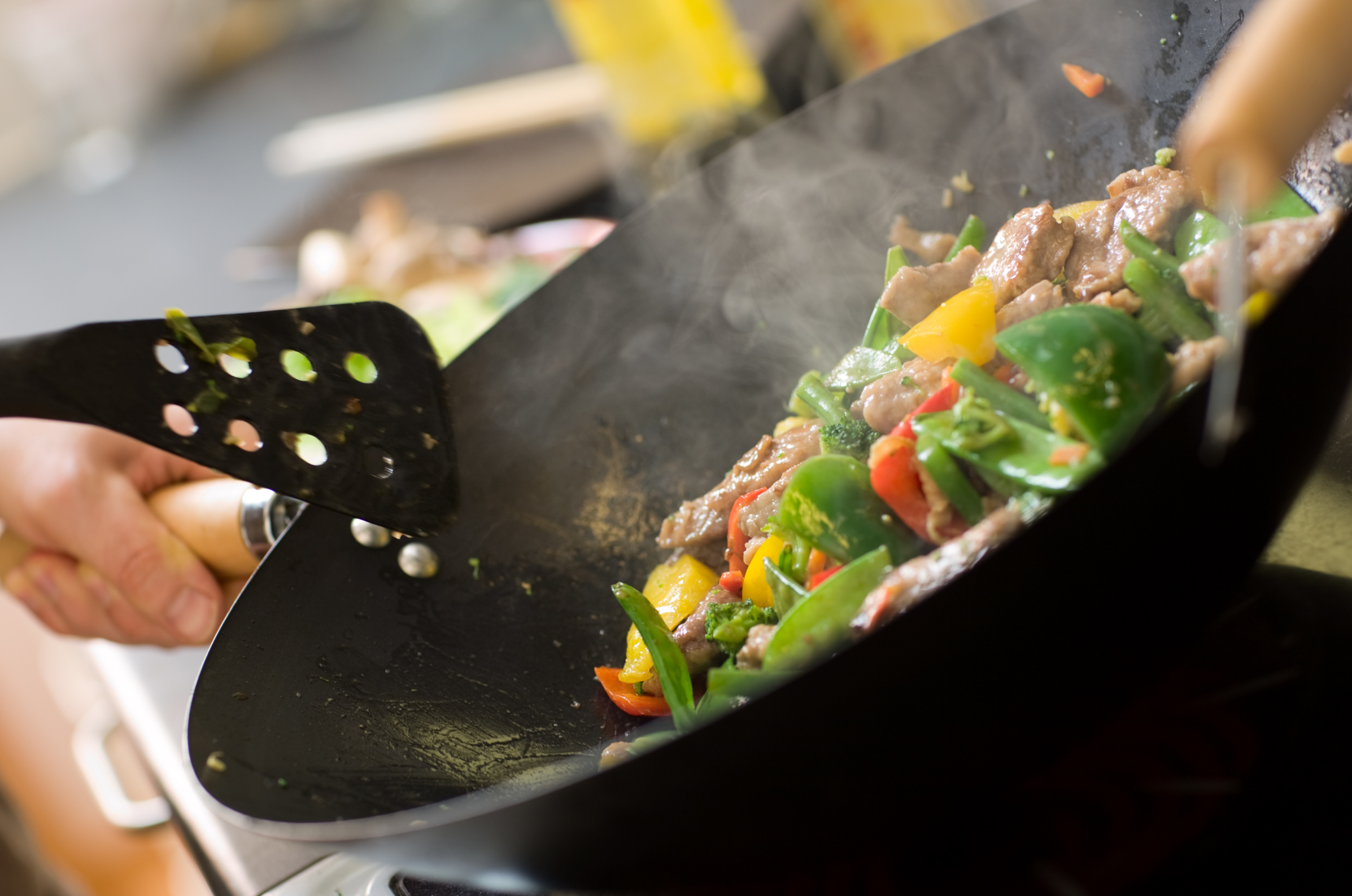 Image of Pro Chefly high-heat stir fry cooking with fresh vegetables and protein in a sizzling wok, capturing bold flavors, chef-driven technique, and everyday kitchen mastery.