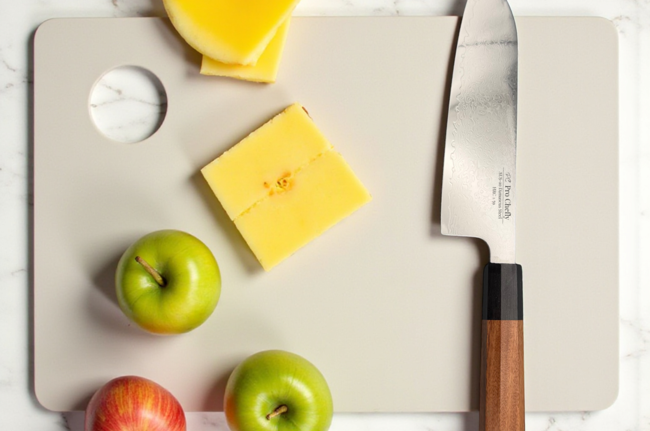 Image of Pro Chefly Damascus Santoku knife on a cutting board with fresh apples and sliced cheese ready for kitchen prep.