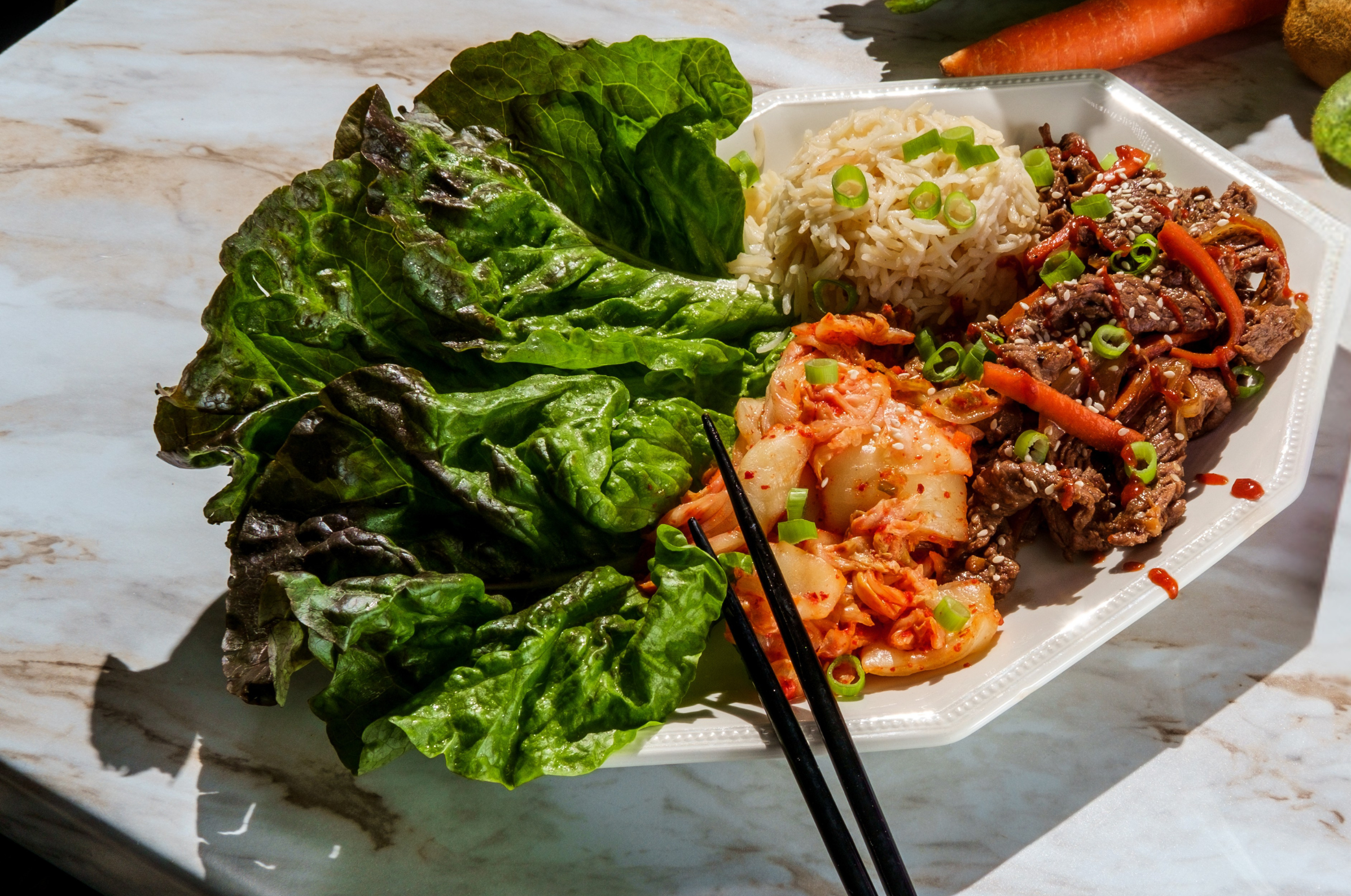Image of Pro Chefly Korean bulgogi lettuce wraps with marinated beef, kimchi, jasmine rice, green onions, and crisp lettuce leaves, vibrant Asian-inspired recipe photography.
