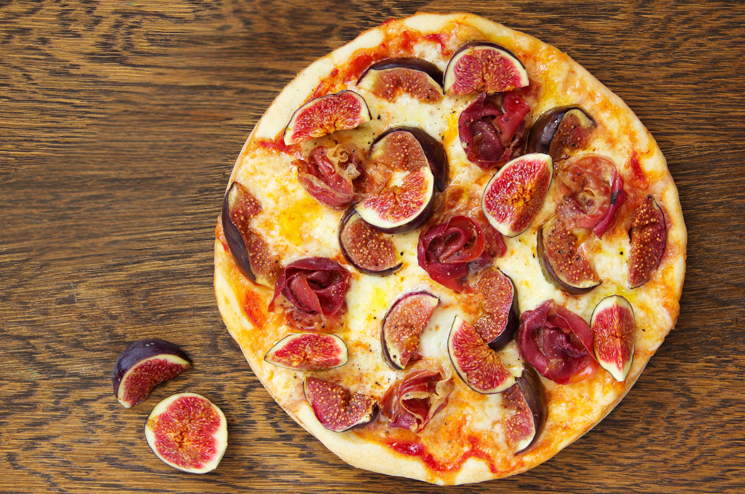 Image of Pro Chefly fig and prosciutto pizza with fresh figs, melted cheese, and crispy golden crust.