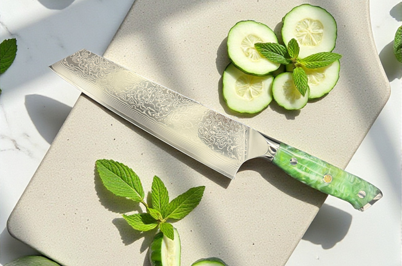 Image of Pro Chefly Damascus kiritsuke knife with a green resin handle displayed beside fresh cucumber slices and mint, showcasing precision and premium craftsmanship.