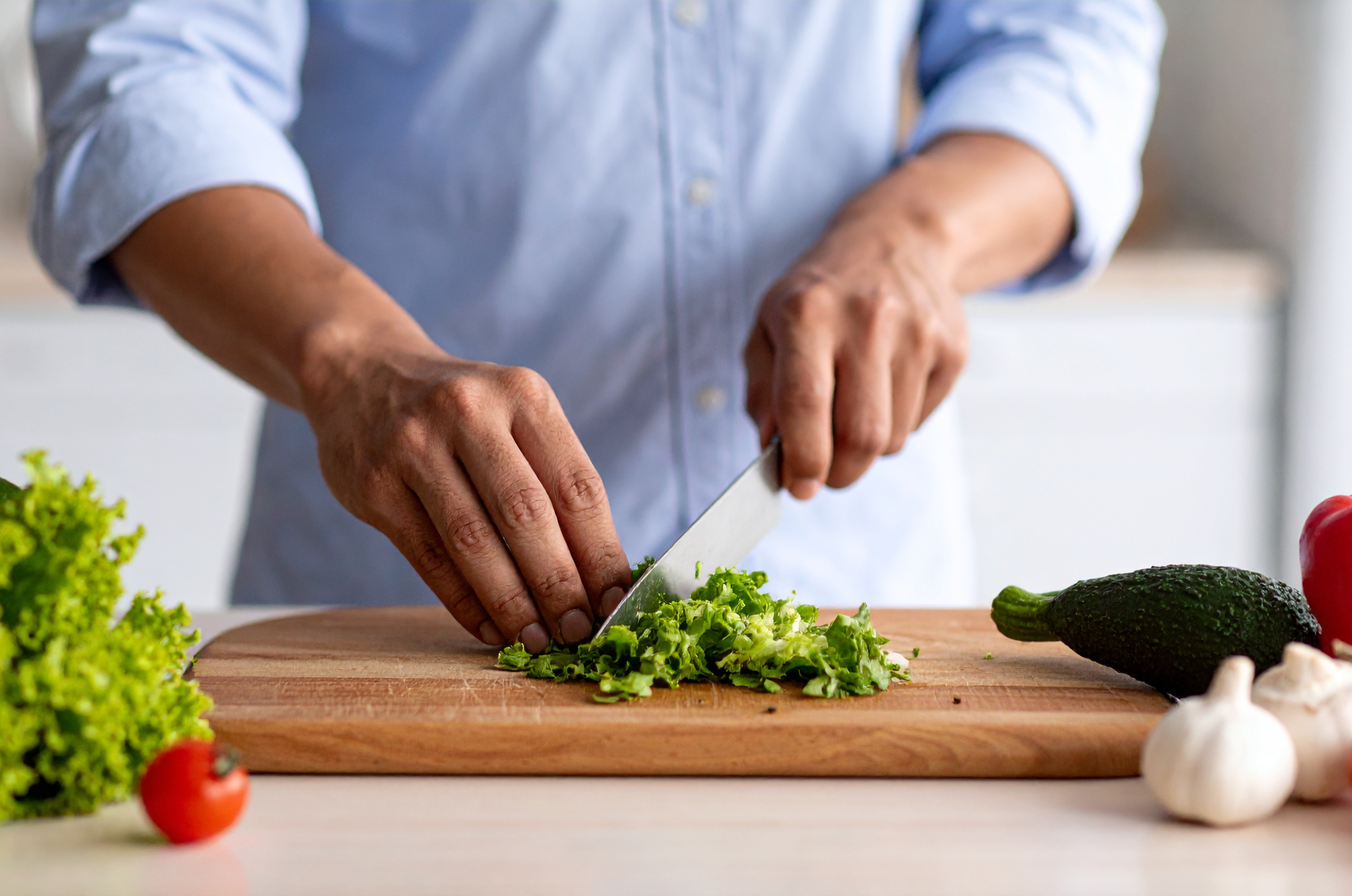 Image of Pro Chefly Aogami Blue #2 knife finely chopping fresh greens on a wooden cutting board, highlighting sharp control and clean everyday prep.