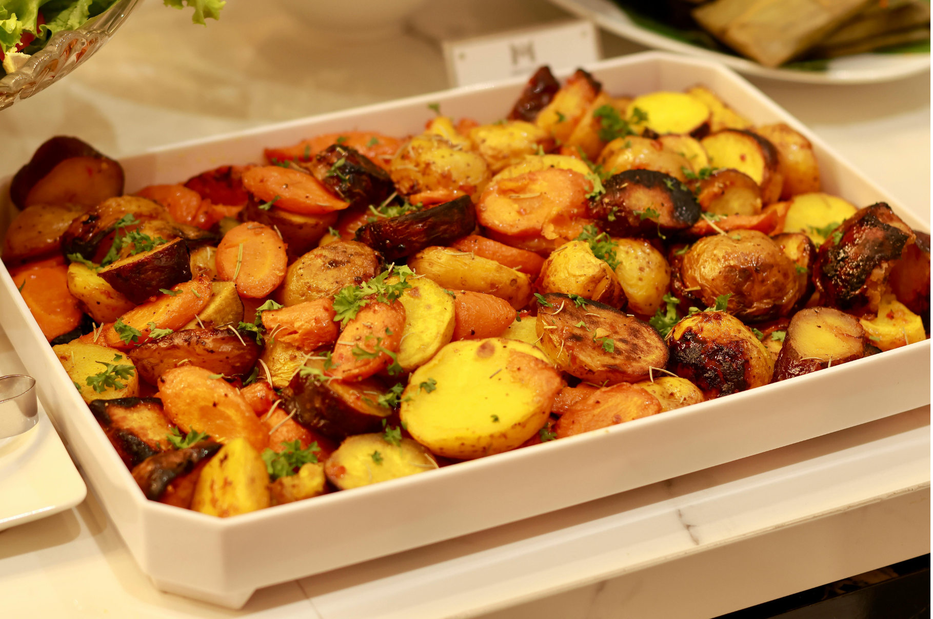 Image of Roasted carrots and potatoes with fresh herbs sliced using a Pro Chefly petty knife, showcasing precision cuts and professional chef quality.
