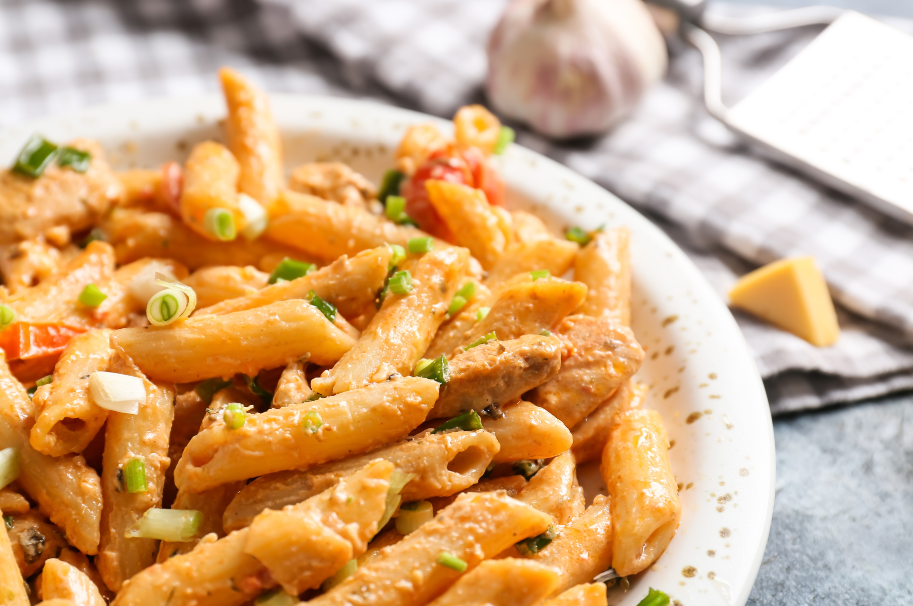 Creamy Cajun pasta with sausage, peppers, and fresh herbs prepared with Pro Chefly chef knives, showcasing bold flavors and professional kitchen precision.