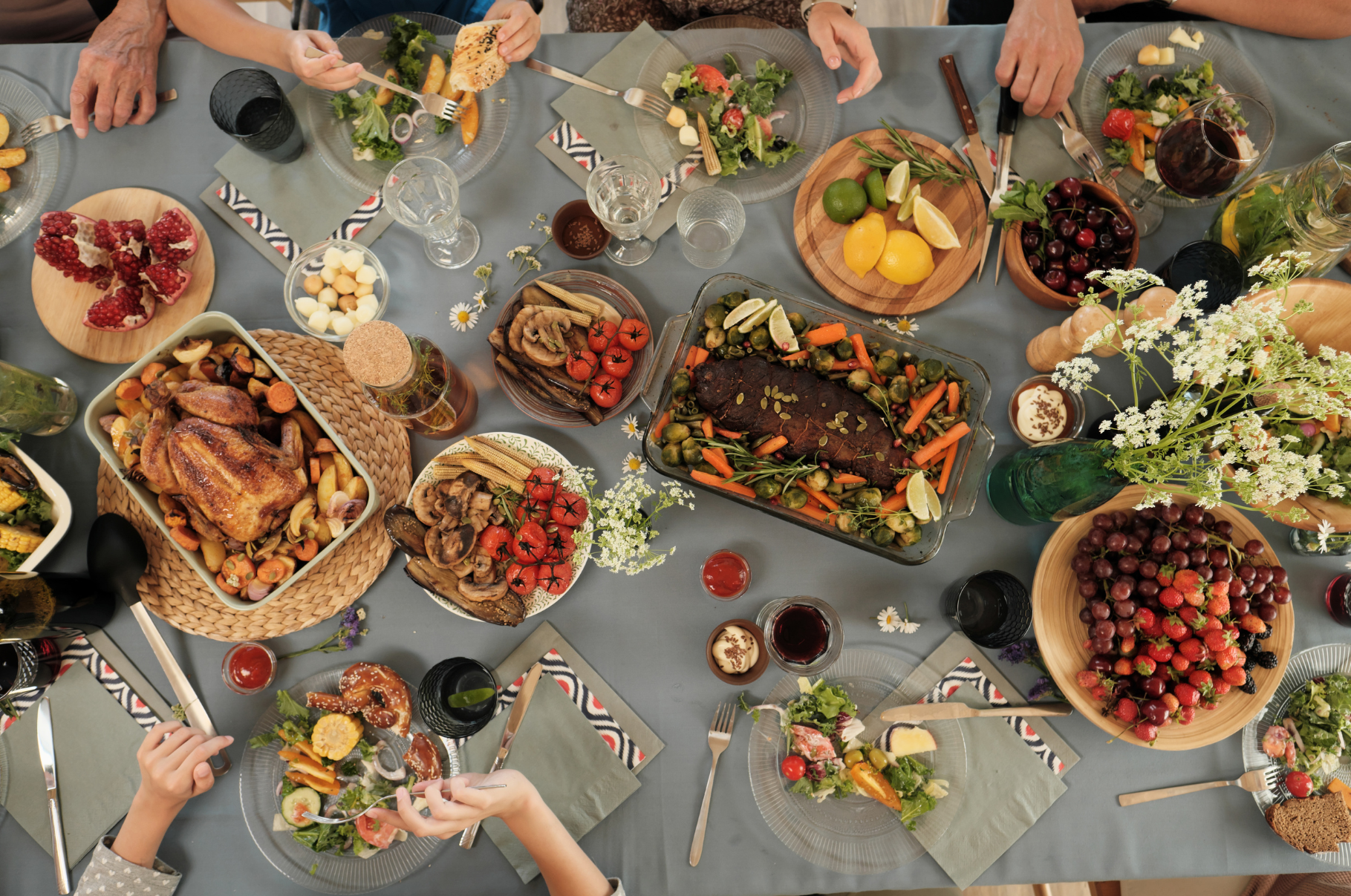 Festive family dinner table with roasted chicken, vegetables, fresh fruit, and sides prepared using Pro Chefly chef knives for a perfect seasonal feast.