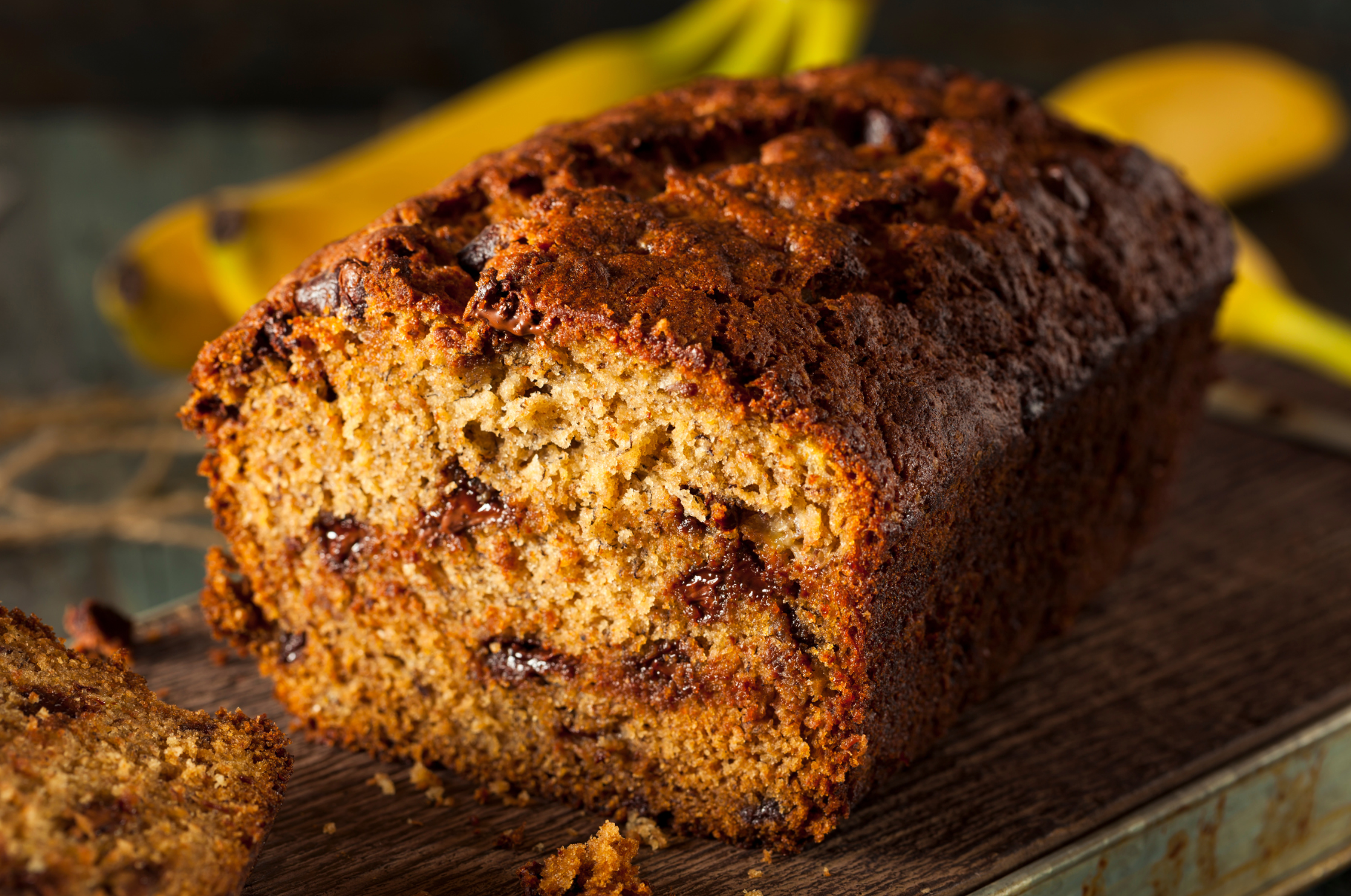 Freshly baked banana bread with chocolate chips sliced cleanly using a Pro Chefly bread knife, ensuring smooth cuts without crumbling.