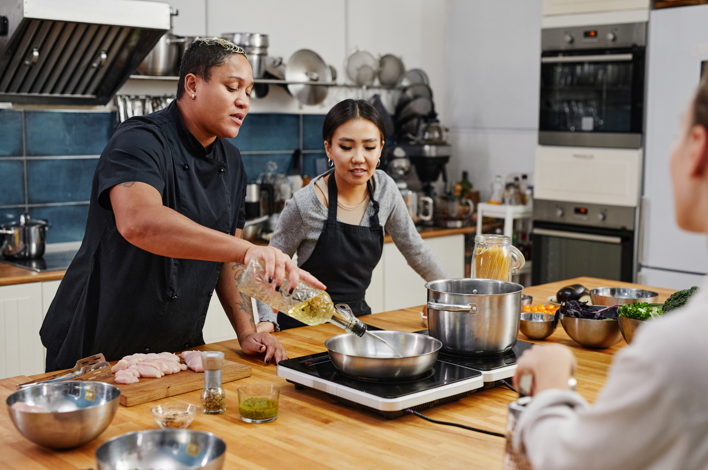 Professional chef teaching a hands-on cooking class using premium Pro Chefly knives in a modern kitchen.