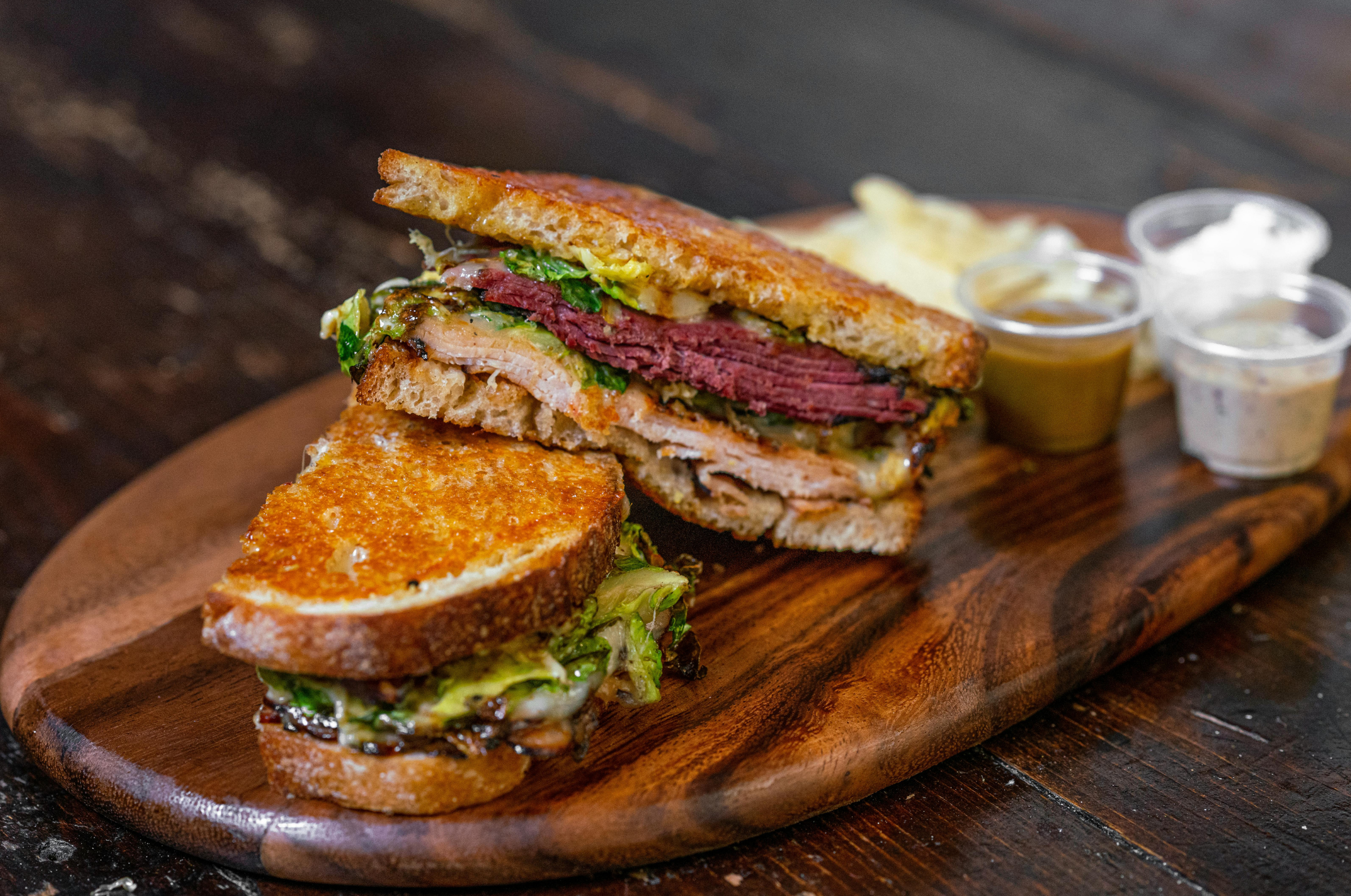 Pro Chefly gourmet sandwich showcasing precise knife cuts, layered meats, and melted cheese on toasted bread—highlighting chef-level craftsmanship and premium presentation.