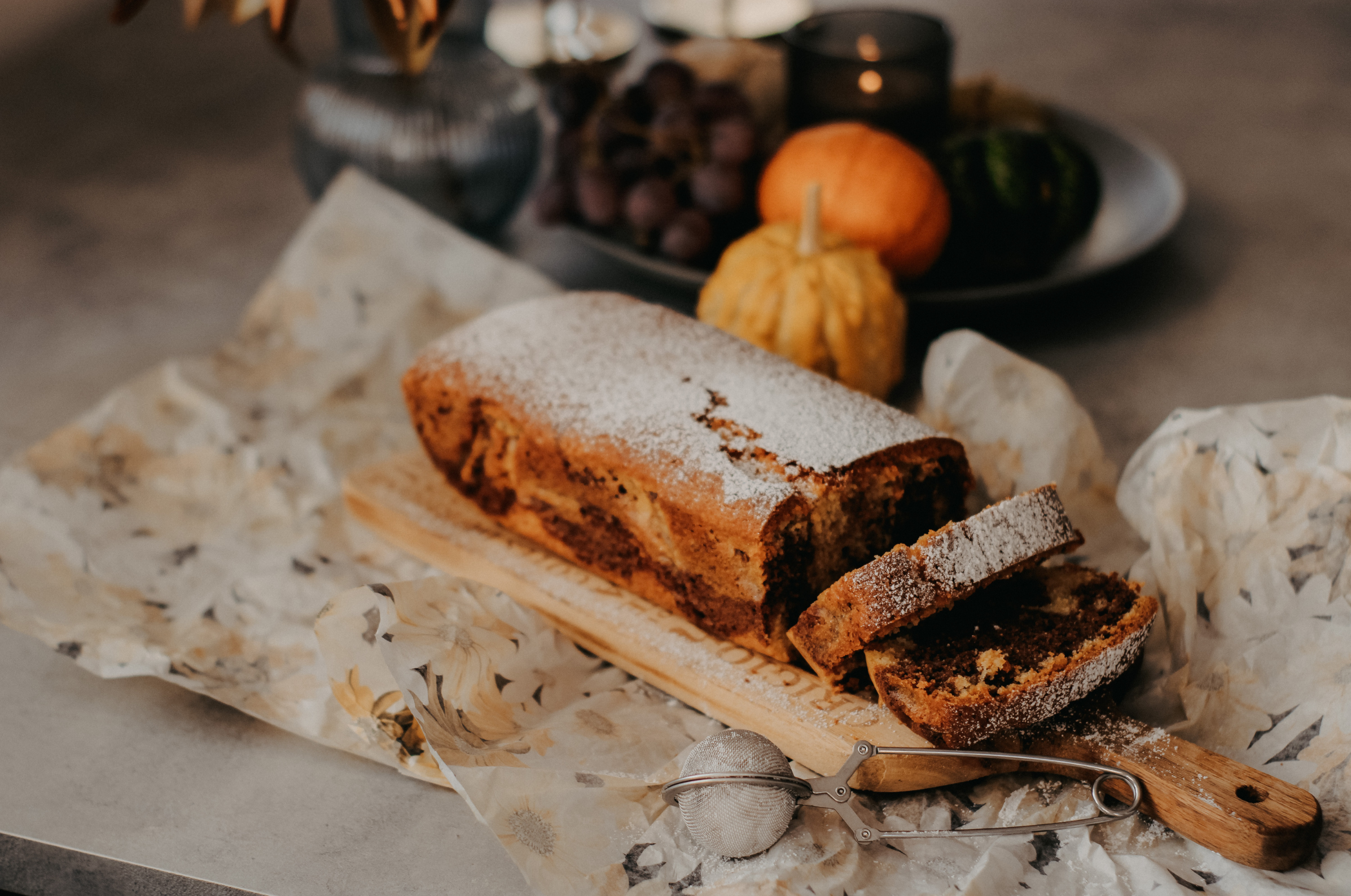 pro chefly spiced loaf cake dusted with powdered sugar on wooden board, capturing cozy fall baking and artisanal presentation