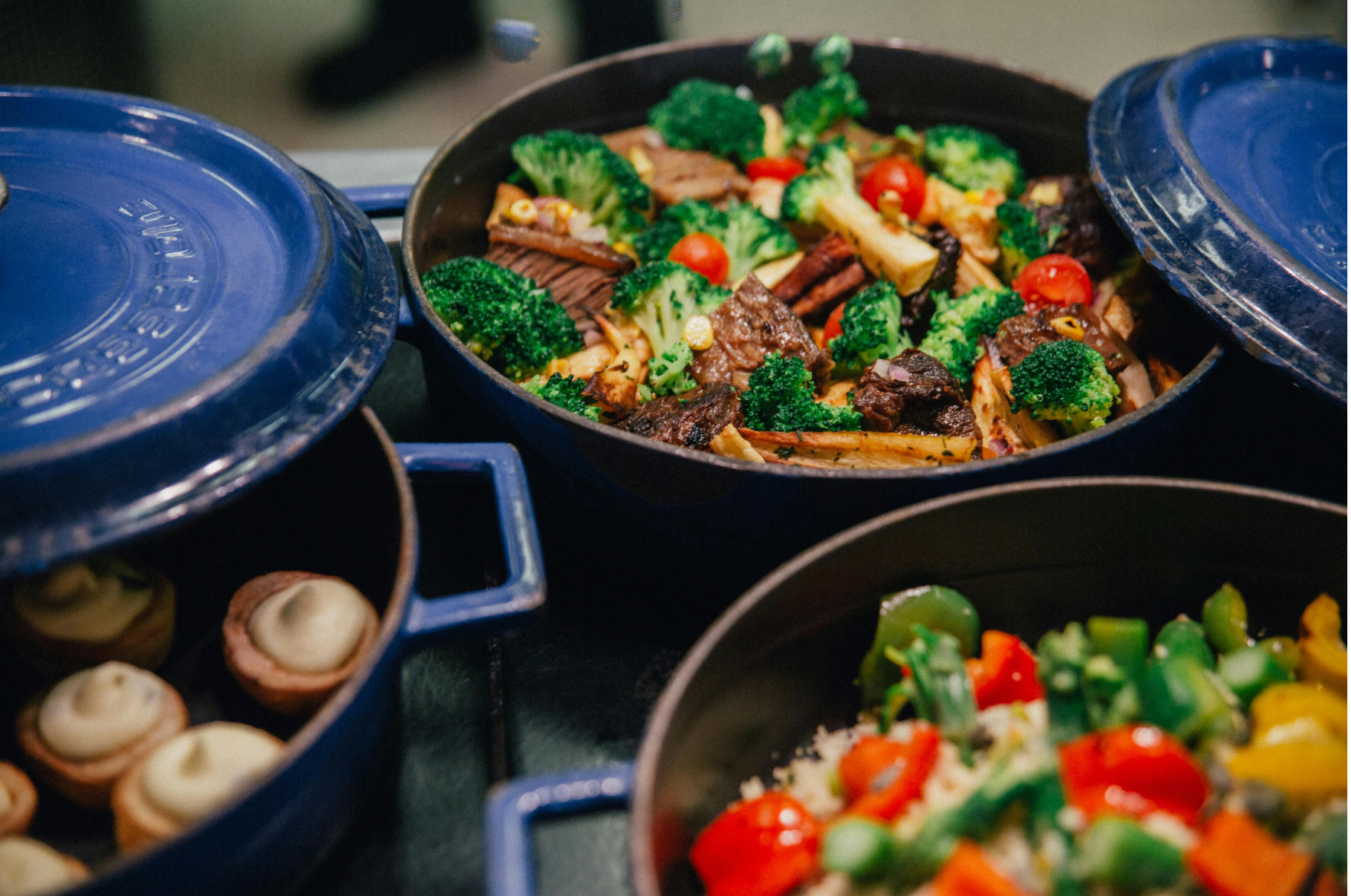 Image of Colorful roasted vegetables and beef in cast iron pots, a dish prepared with precision using a Japanese Damascus chef knife – Pro Chefly