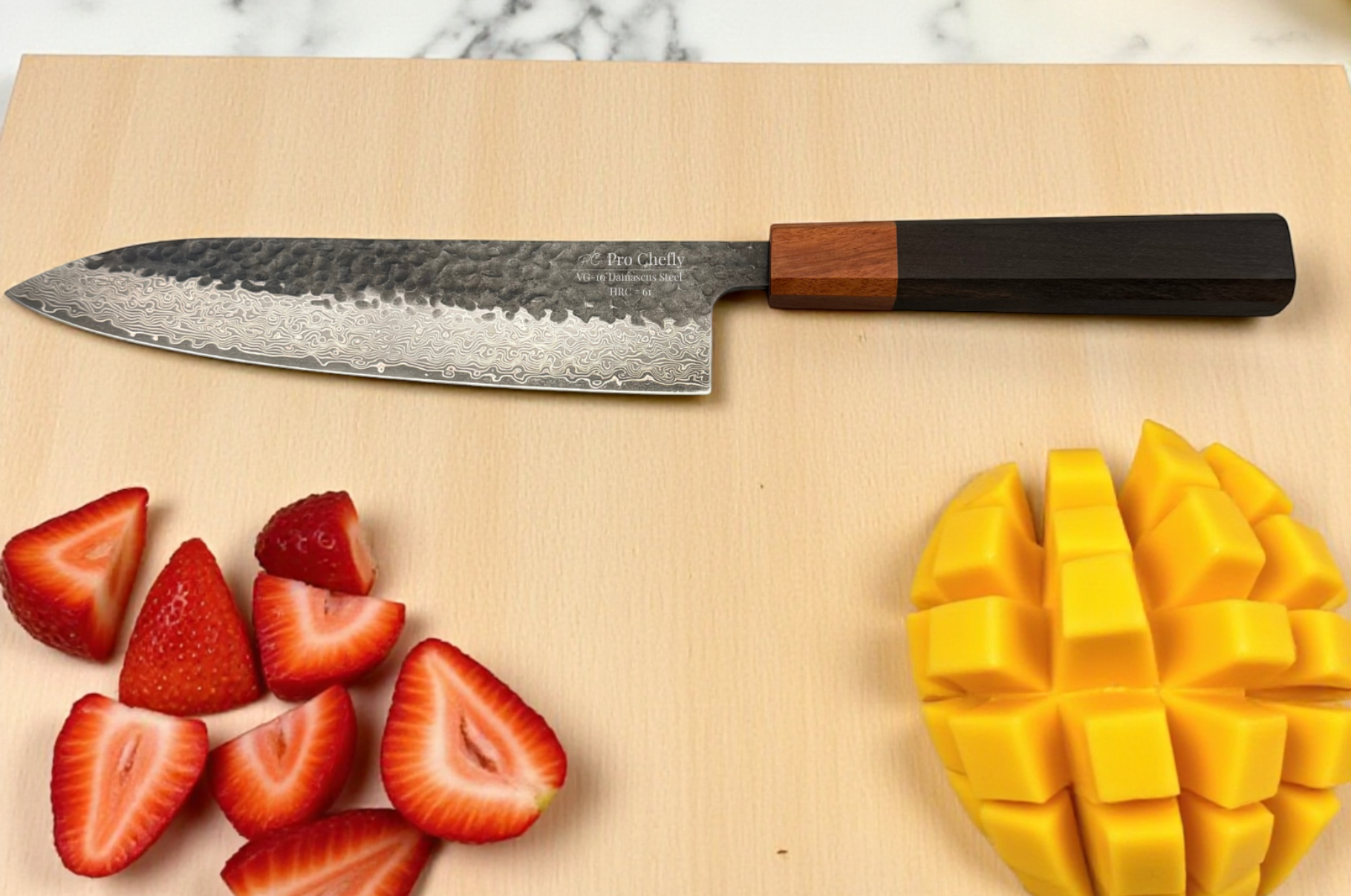 Image of Pro Chefly Damascus chef knife on a light cutting board with sliced strawberries and diced mango, showcasing Japanese steel precision and premium kitchen craftsmanship.