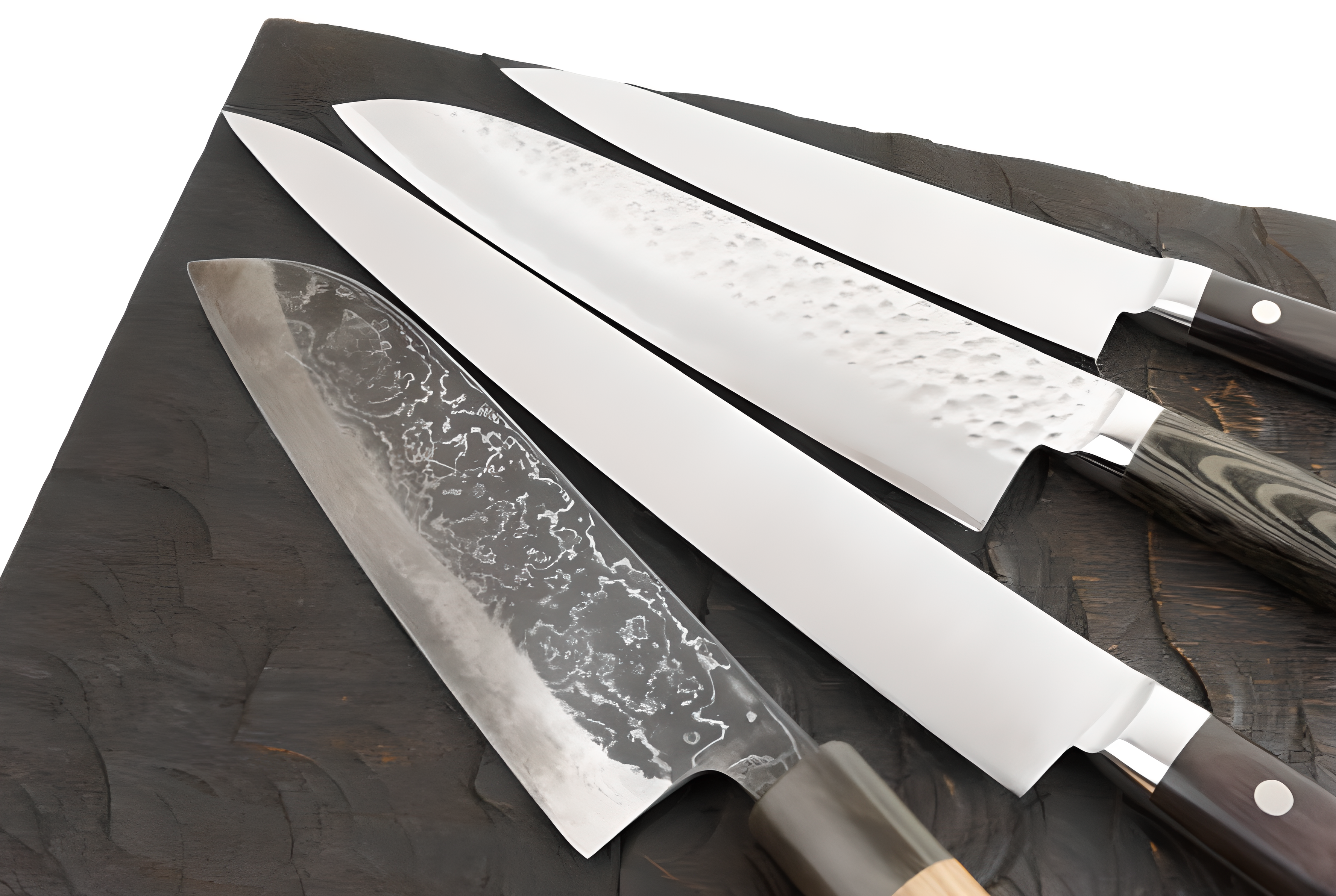 Set of Japanese Damascus chef knives with patterned steel blades and wooden handles, displayed on a dark textured cutting board – Pro Chefly