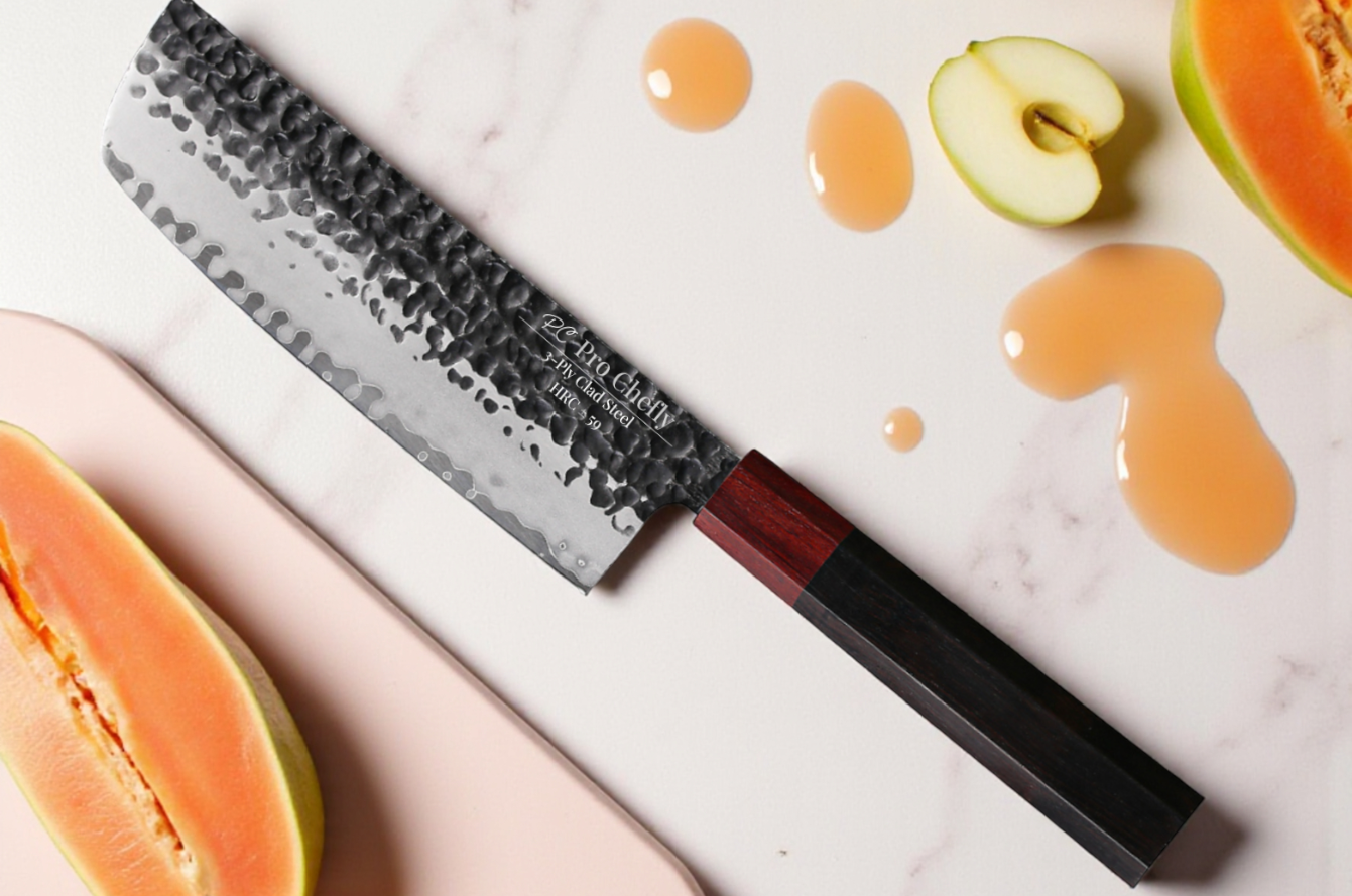 Image of Pro Chefly Damascus vegetable knife on white marble beside sliced papaya and apples with fresh juice drips, highlighting the hammered blade and wood handle.