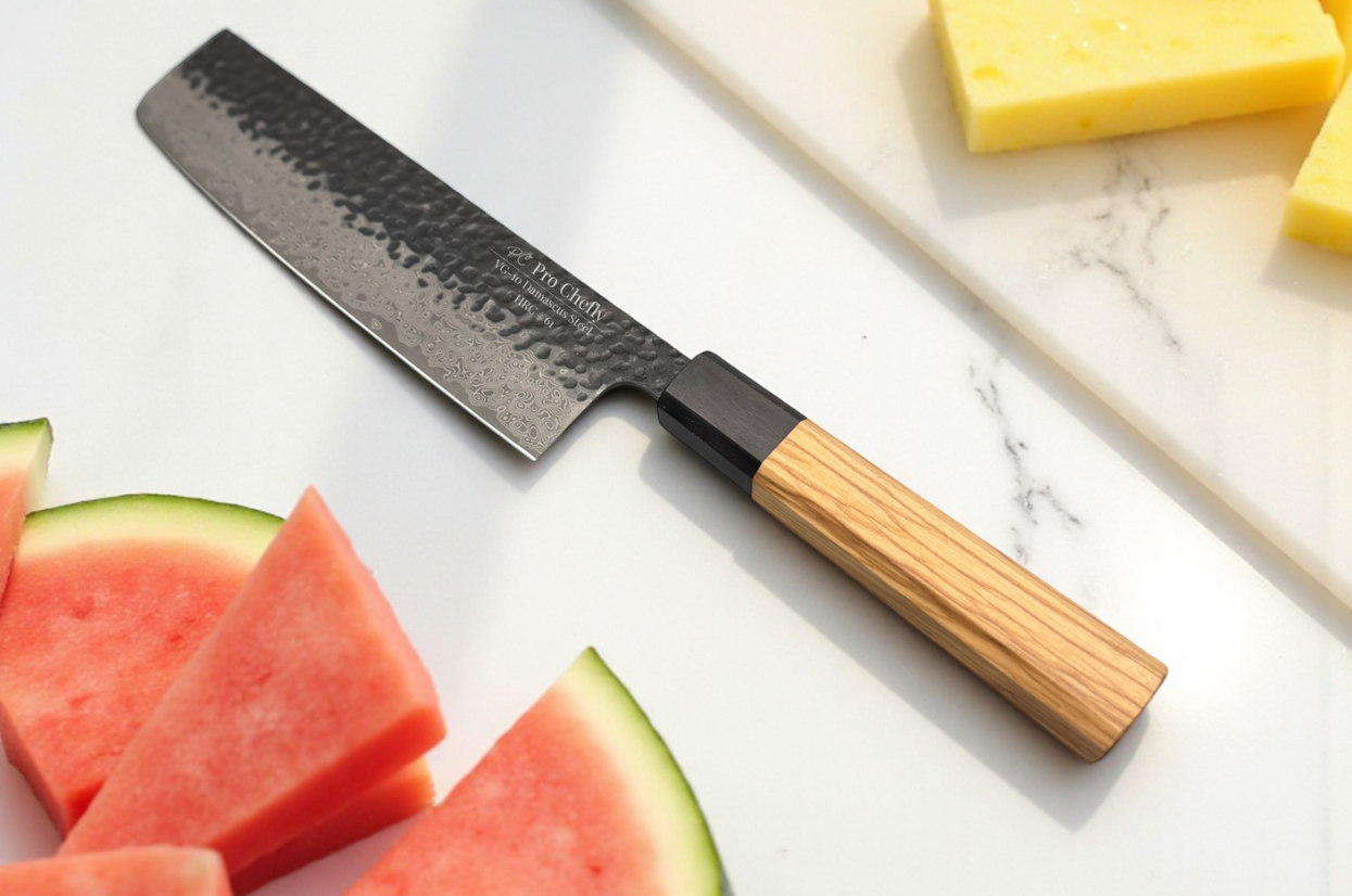 Pro Chefly Damascus knife on a marble surface beside sliced watermelon and cheese.