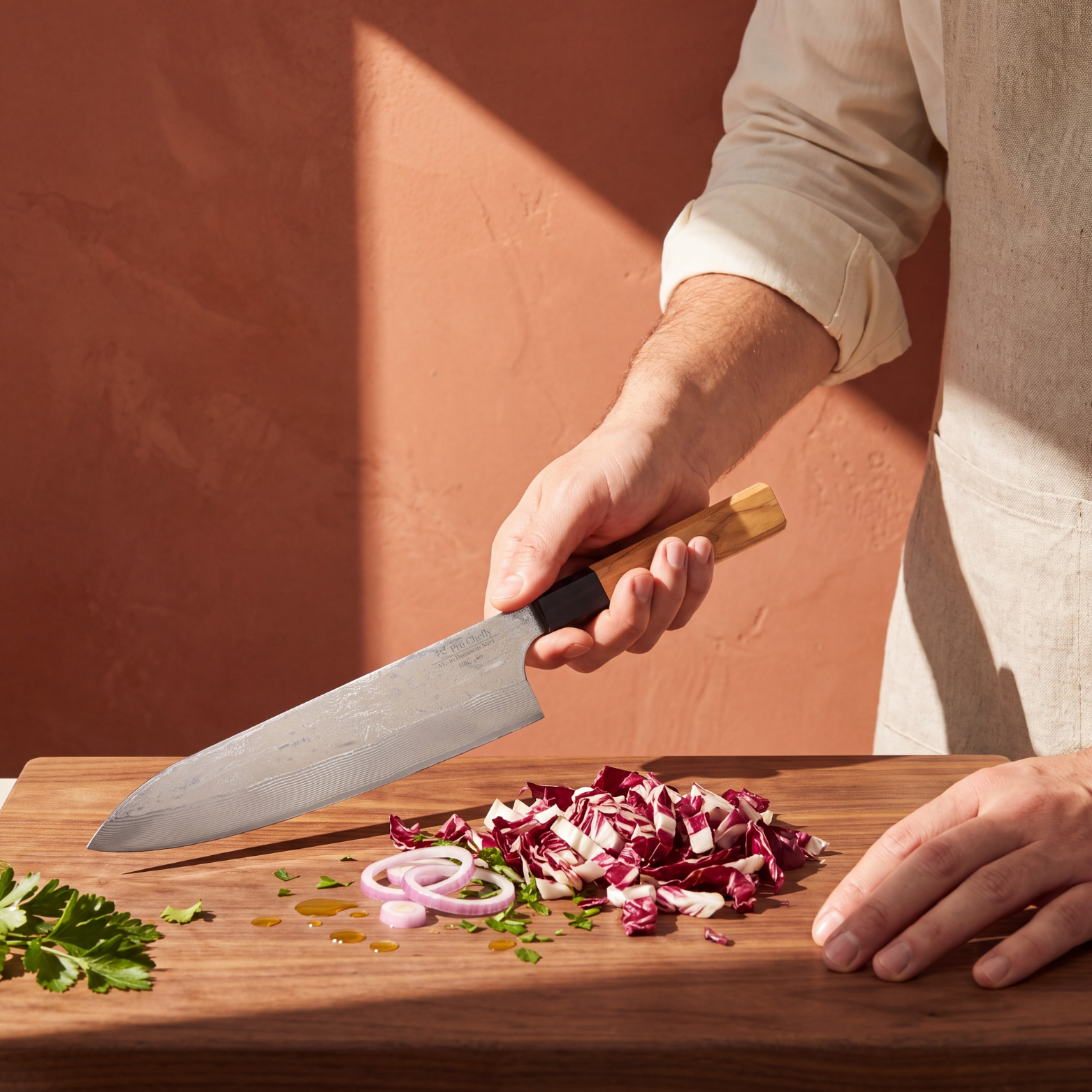 Pro Chefly 9-inch Damascus gyuto chef knife with olivewood wa handle, chopping radicchio on a walnut board