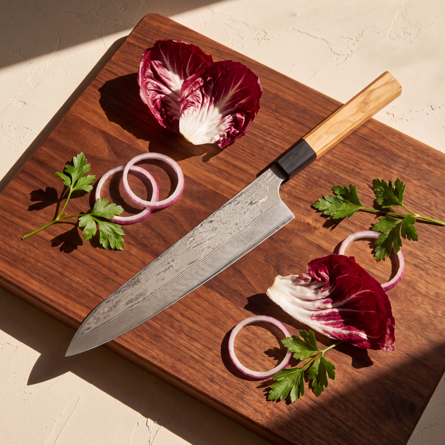 Pro Chefly 9-inch Damascus gyuto chef knife with olivewood wa handle, on a walnut board with radicchio, red onion and parsley