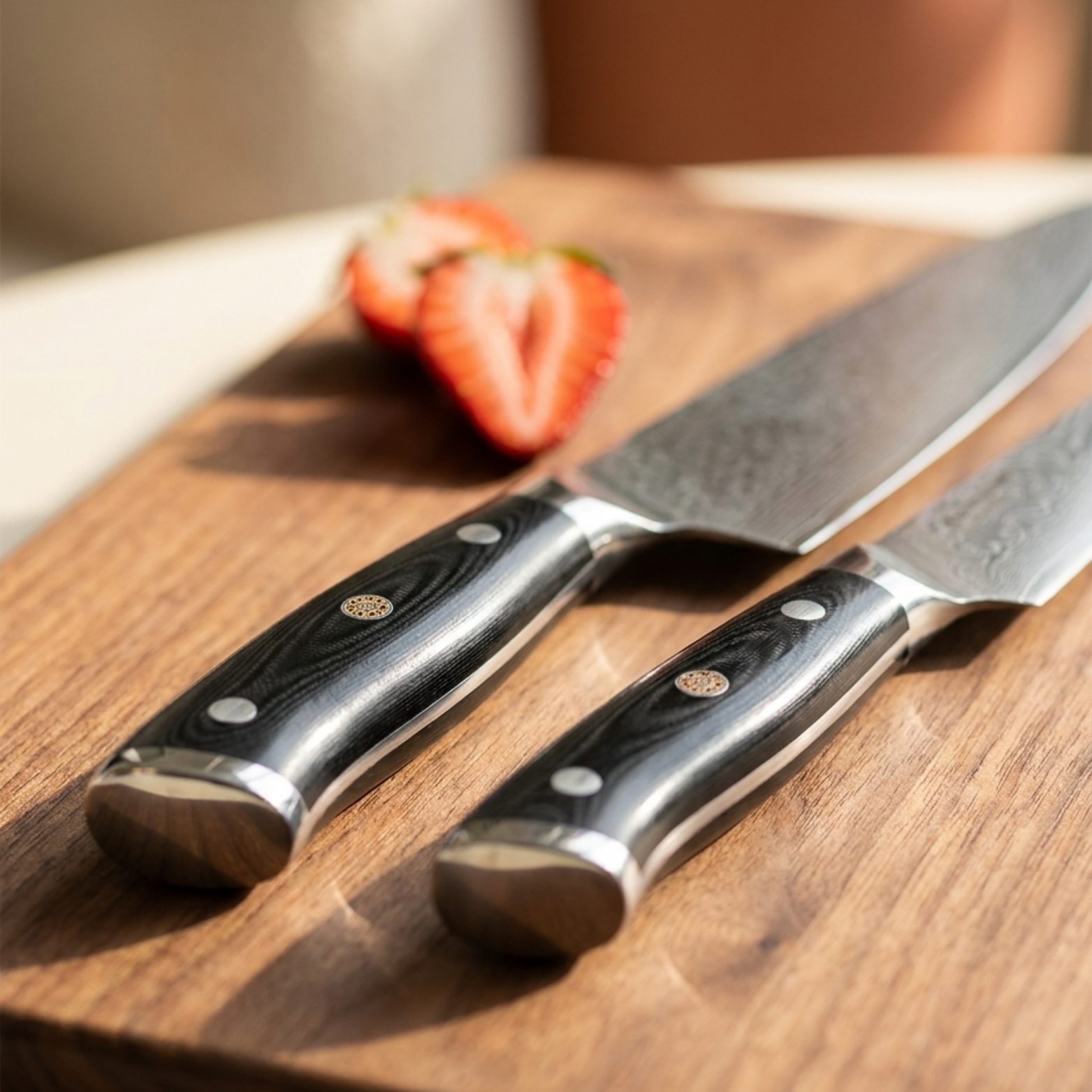 Image of Pro Chefly 2-piece Damascus knife set with black triple-riveted G10 handles, close-up on a walnut board with a halved strawberry