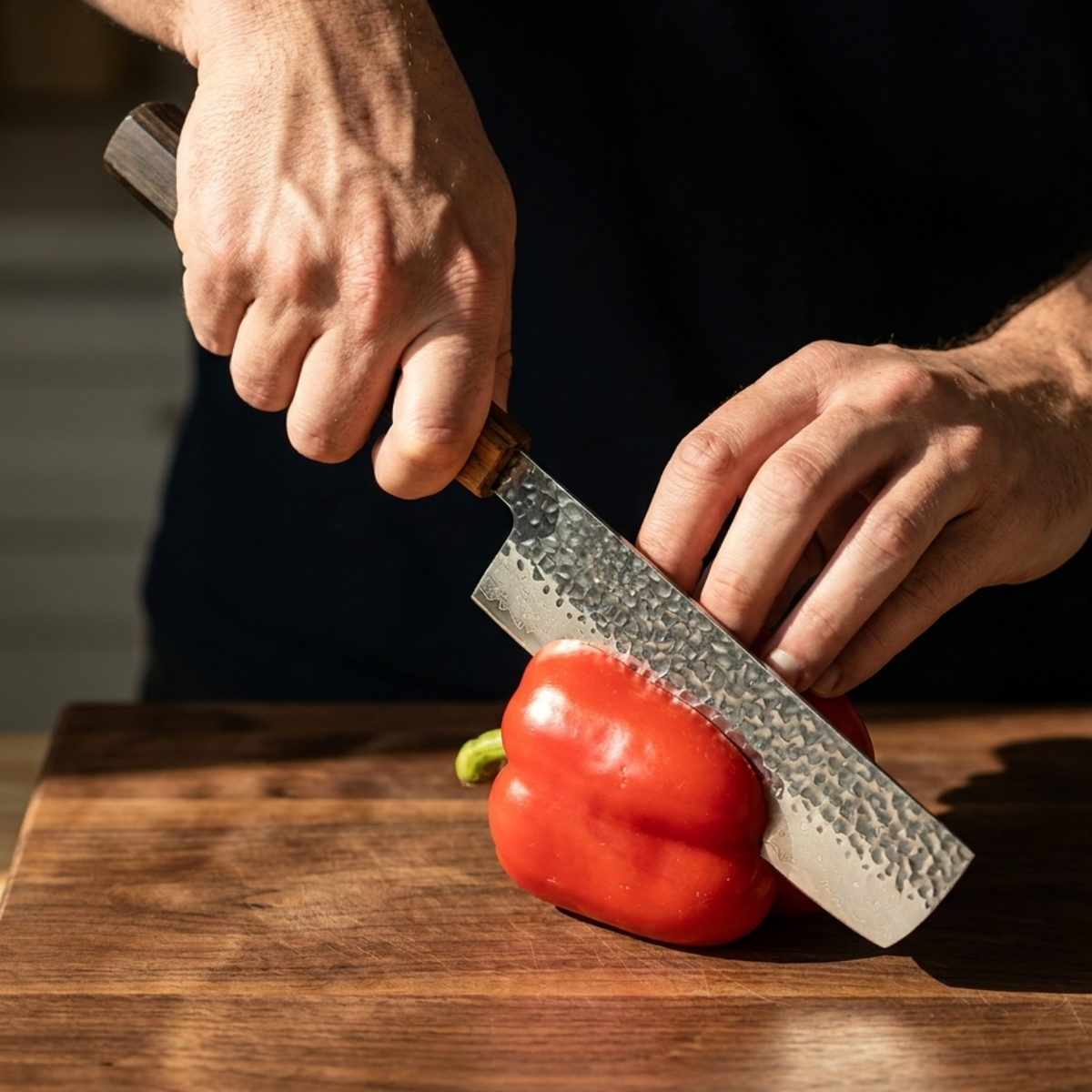 Pro Chefly 3-piece Damascus knife set with black-and-amber pakkawood wa handle, halving a red bell pepper on a walnut board