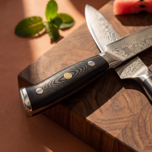 Image of Pro Chefly 3-piece Damascus knife set, close-up of the riveted handle with gold mosaic pin and steel bolster