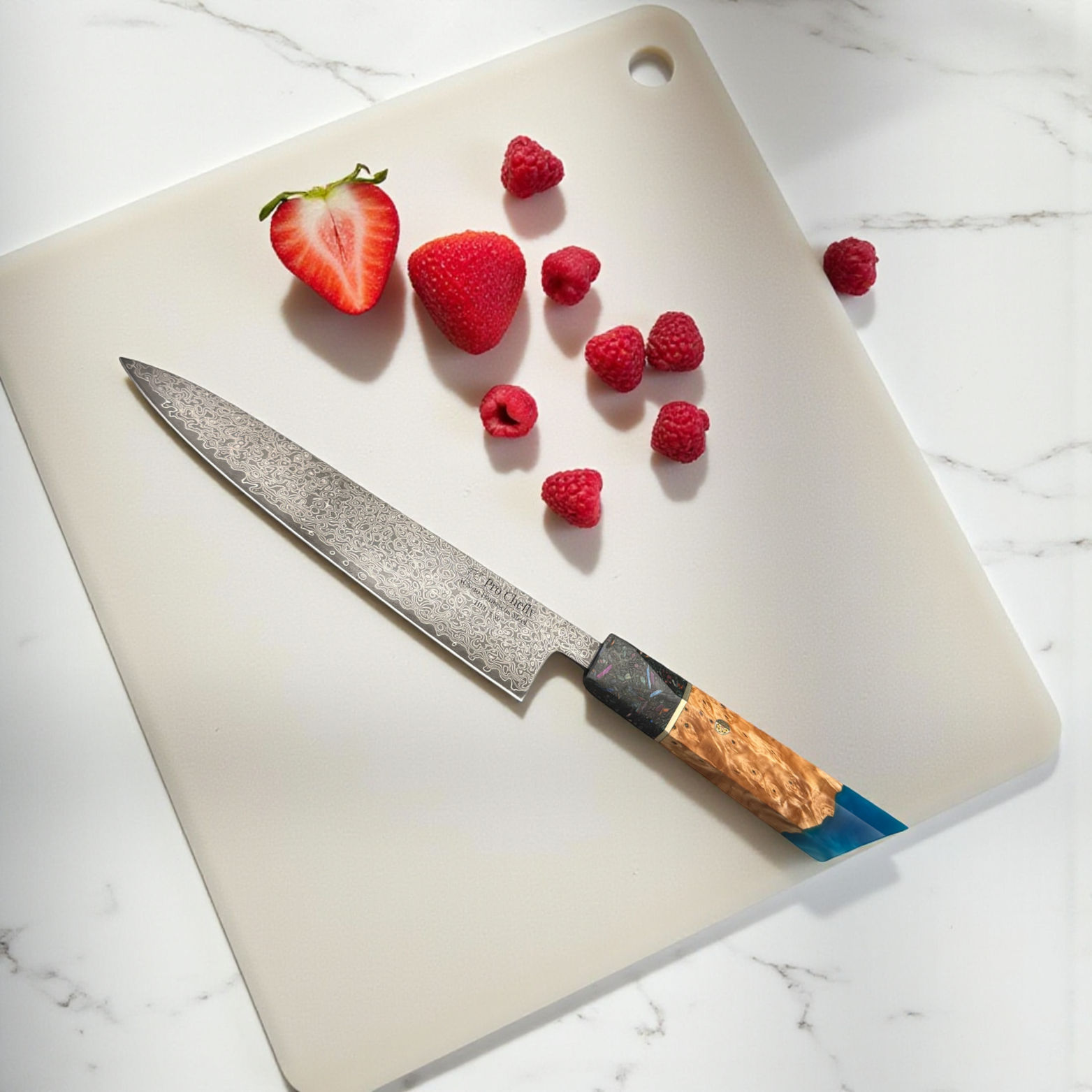 Image of Pro Chefly AUS-10 Damascus steel Japanese gyuto knife with resin and wood handle slicing strawberries on marble countertop.