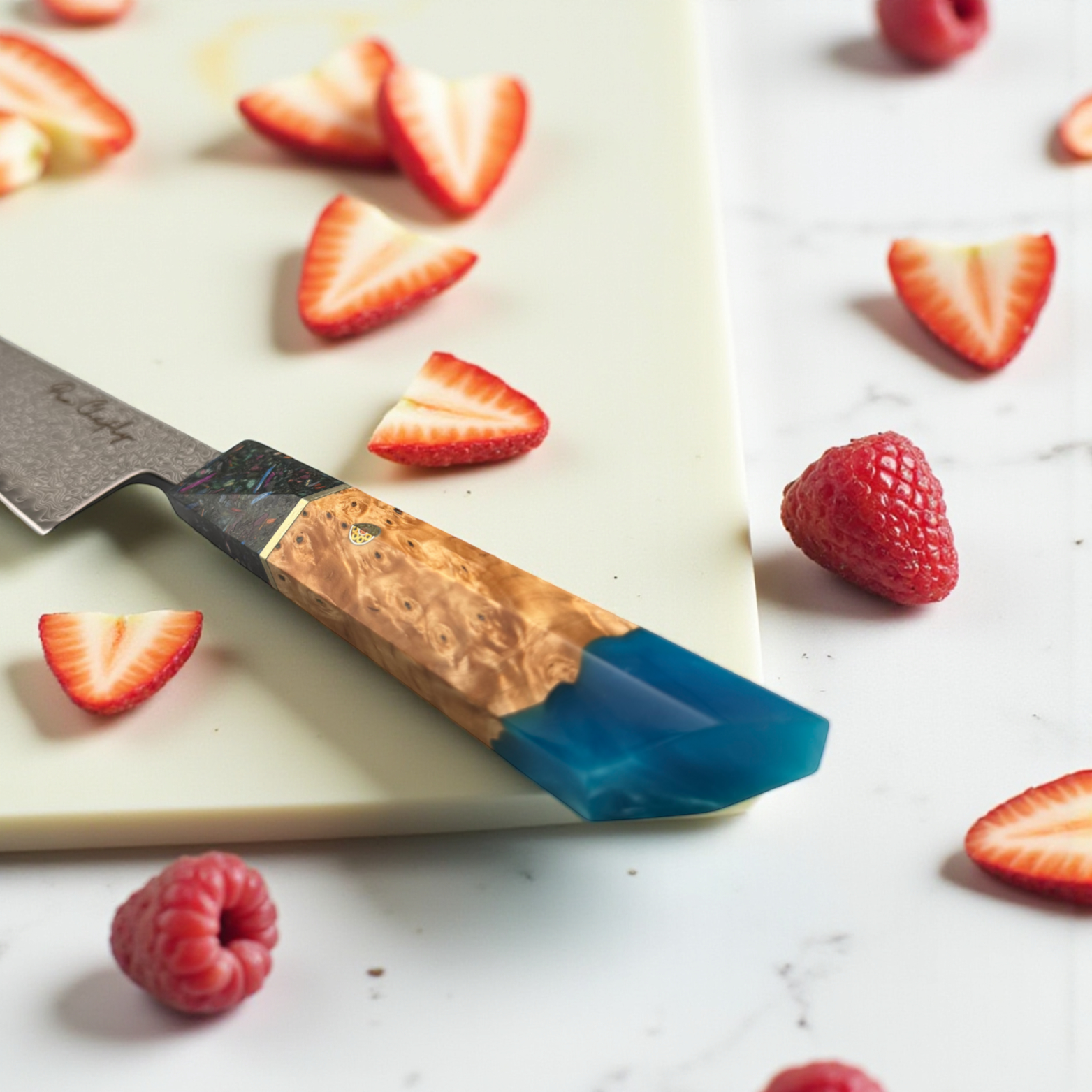 Image of Pro Chefly AUS-10 Damascus steel Japanese gyuto knife with resin and wood handle surrounded by strawberry hearts on cutting board.