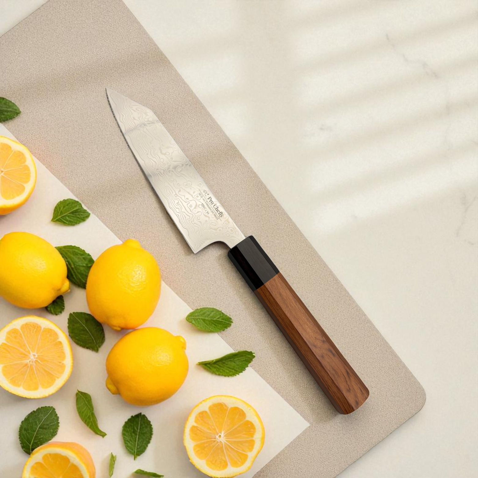 Pro Chefly AUS-10 Damascus steel Japanese mini bunka knife with rosewood octagon handle on white board with lemon slices in sunlight.