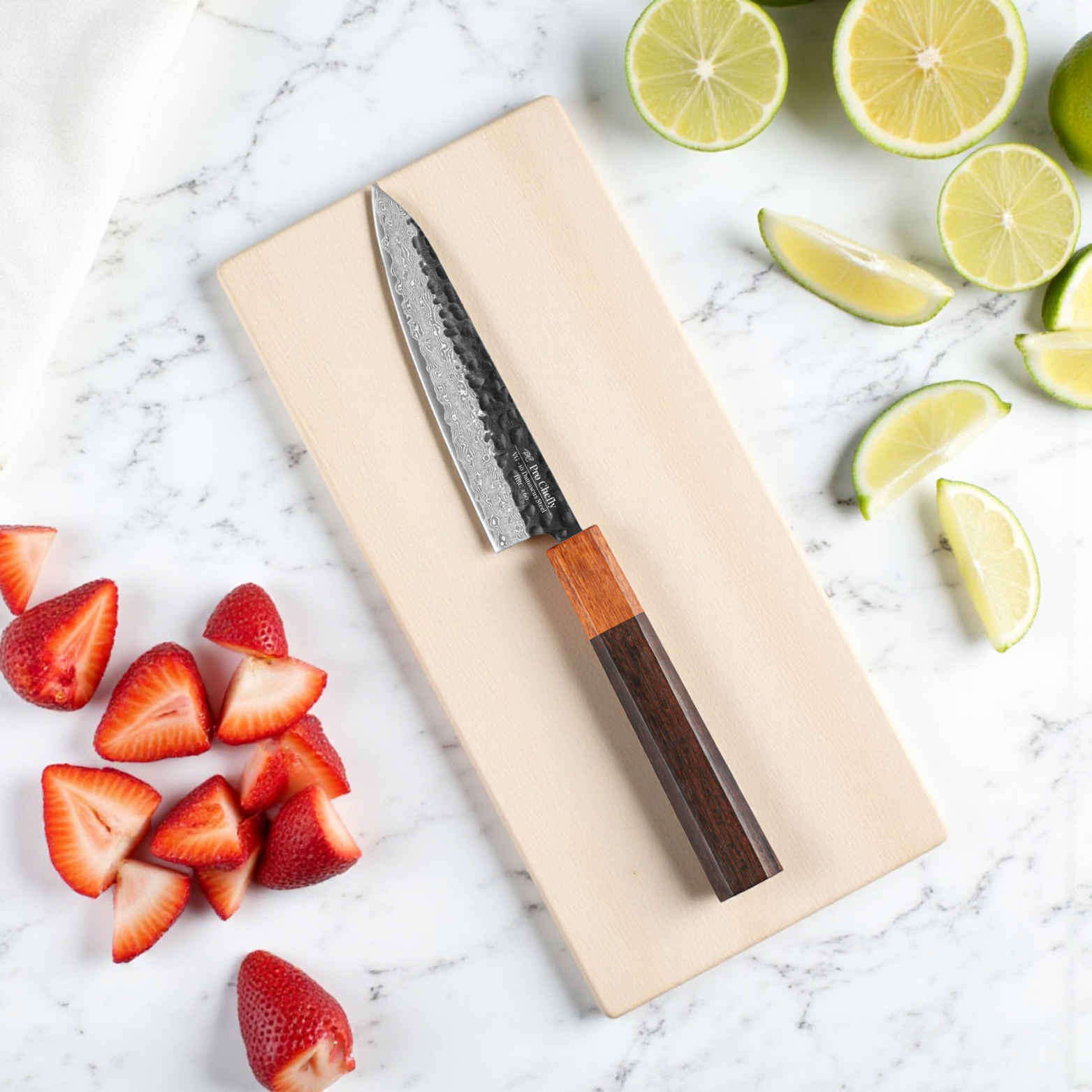 Image of Pro Chefly VG-10 Damascus steel Japanese petty knife with rosewood handle on cutting board with strawberries and lime.