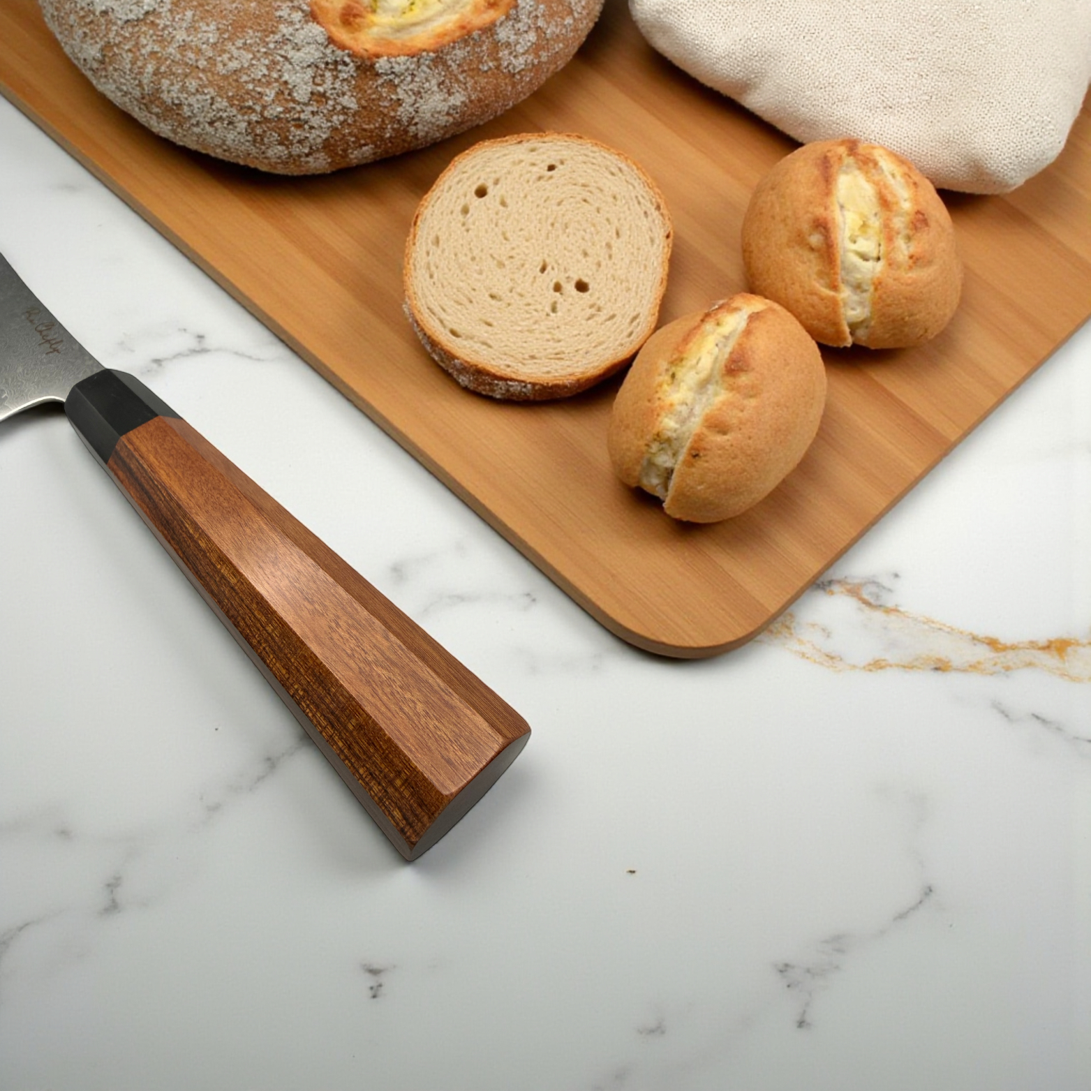 Image of Pro Chefly VG-10 Damascus serrated bread knife with rosewood octagon handle next to fresh sliced artisan bread.
