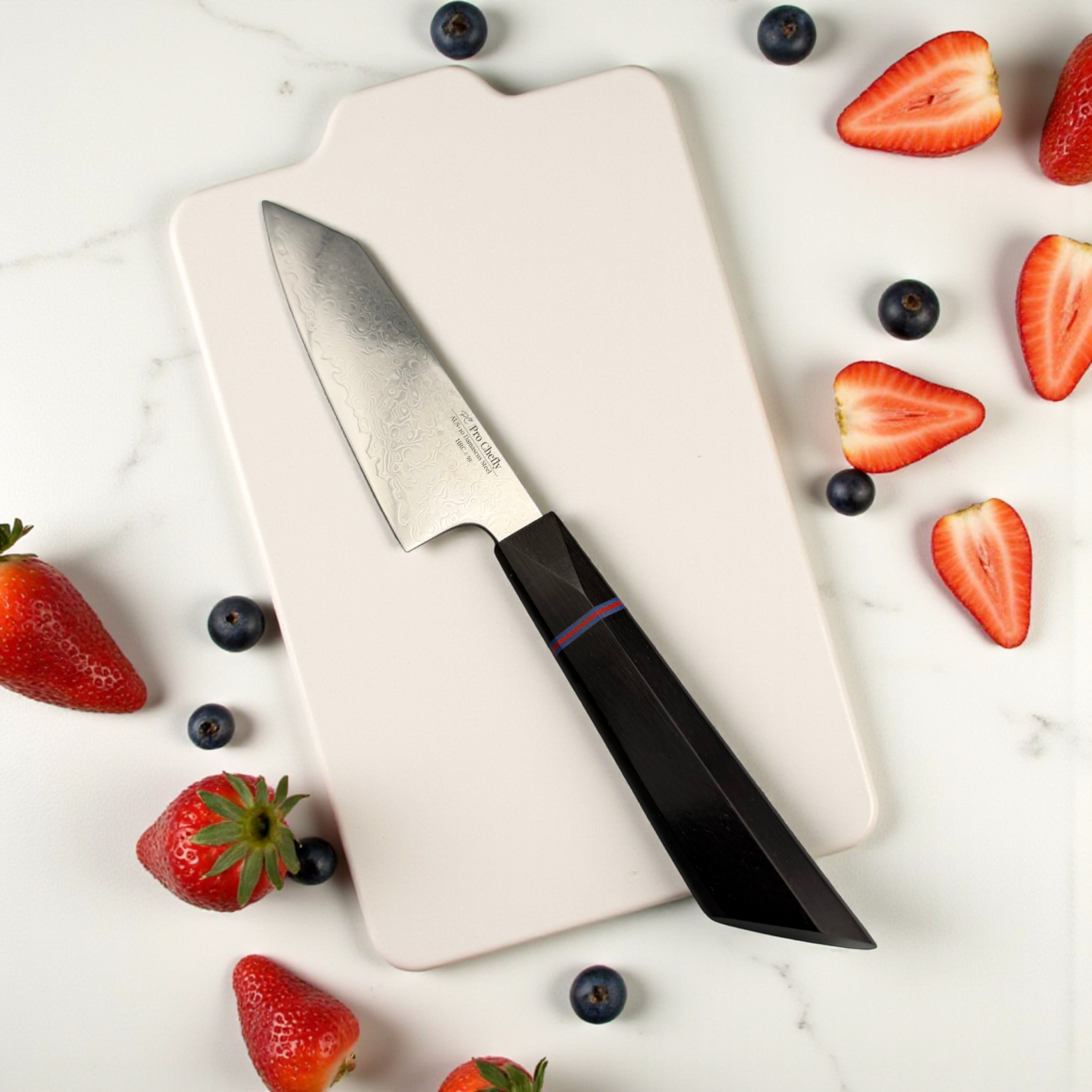 Image of Pro Chefly AUS-10 Damascus steel Japanese petty knife with scattered sliced strawberries on a marble prep surface.