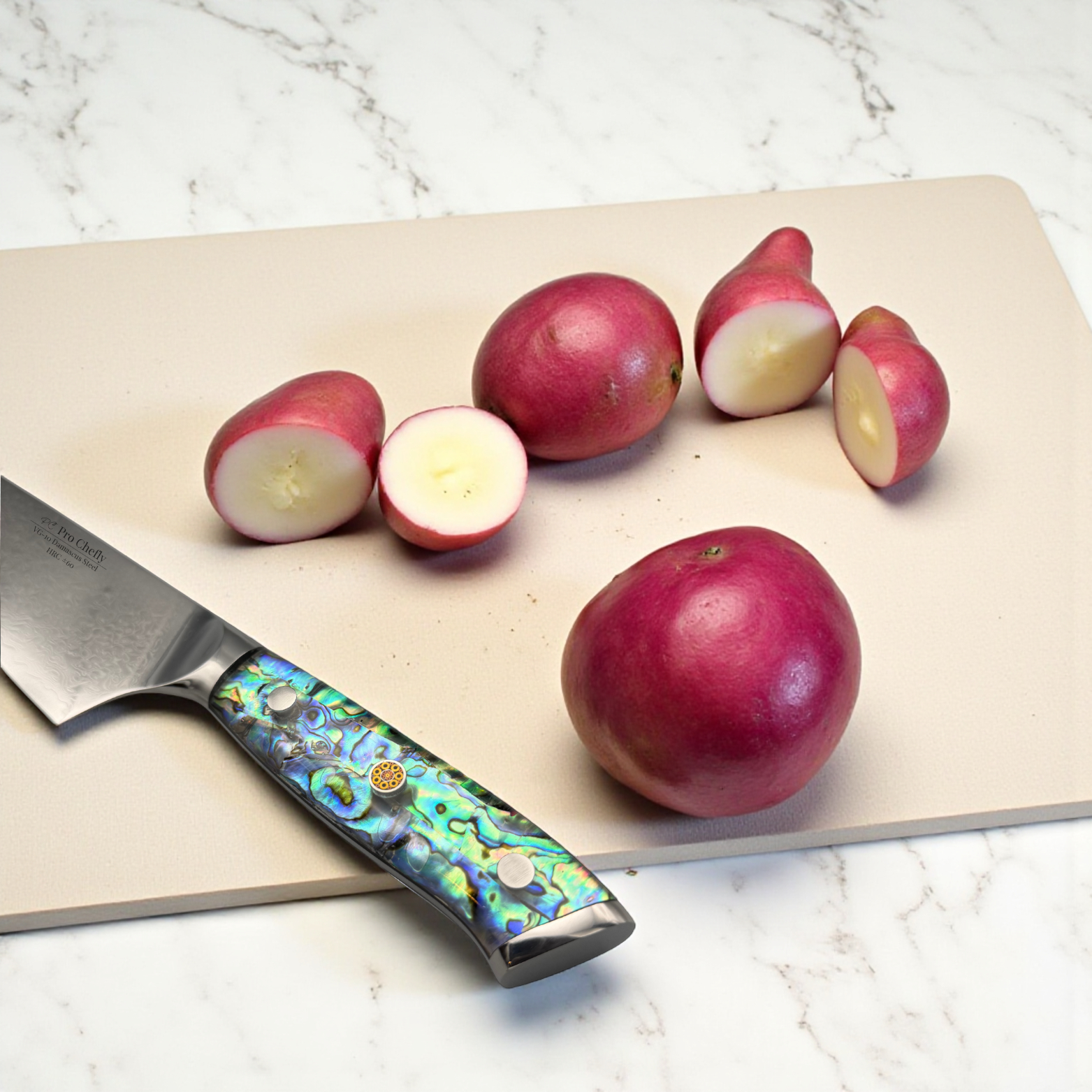 Image of Pro Chefly VG-10 Damascus Santoku Knife with resin handle next to halved red potatoes on a marble surface.