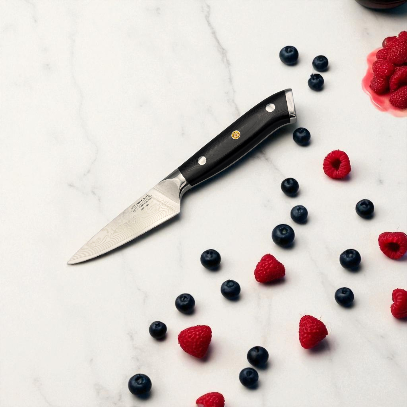 Image of Pro Chefly VG-10 Damascus steel Japanese paring knife with G10 fiberglass handle next to scattered berries on marble plate.