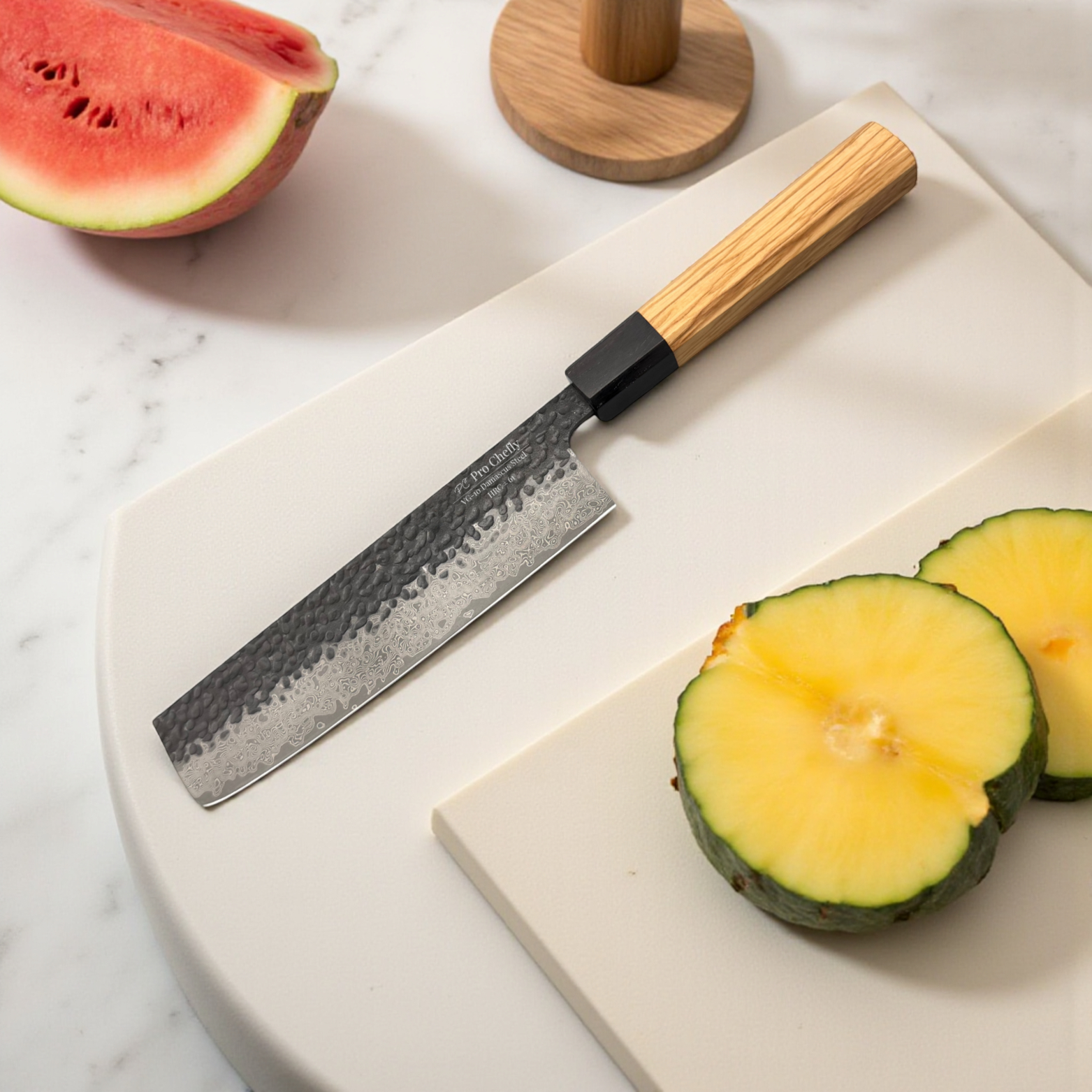 Image of Pro Chefly VG-10 Damascus steel Japanese nakiri knife with olivewood handle on cutting board beside sliced watermelon and melon.