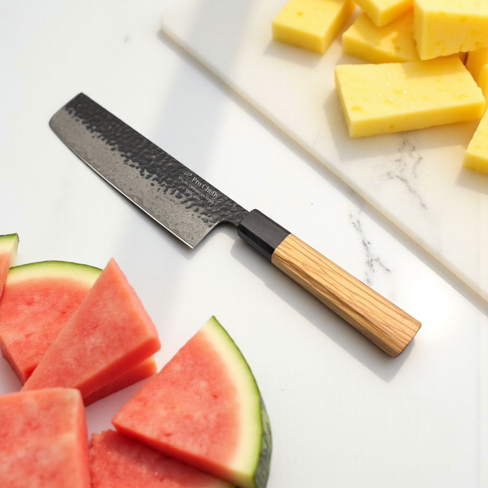 Image of Pro Chefly VG-10 Damascus steel Japanese nakiri knife with olivewood handle on cutting board with watermelon and pineapple slices.