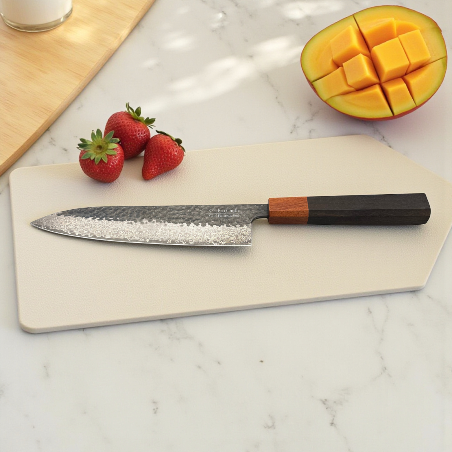 Image of Pro Chefly VG-10 Damascus steel Japanese chef knife with pakkawood handle on cutting board with a scored mango half and strawberries.
