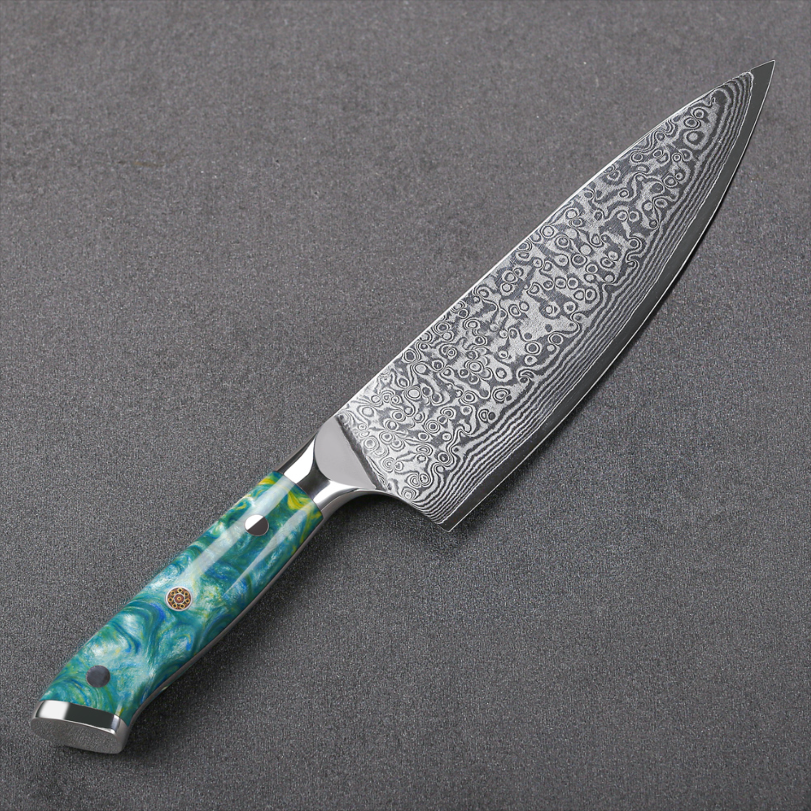 Image of Pro Chefly VG-10 Damascus steel Japanese chef knife with resin handle angled on dark stone surface.