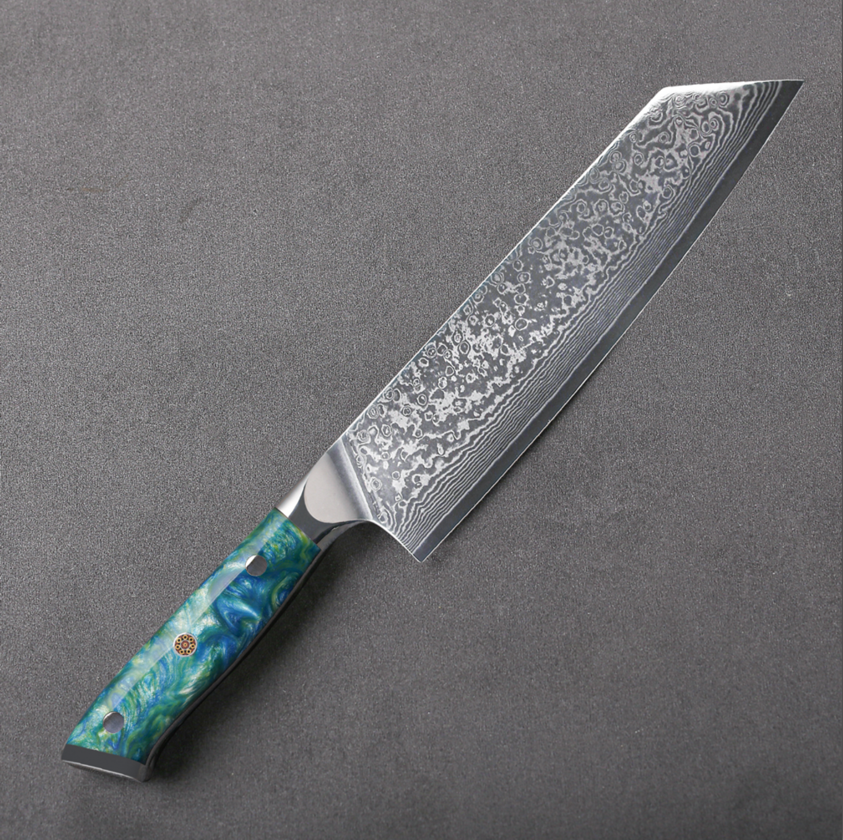 Image of Pro Chefly VG-10 Damascus steel Japanese kiritsuke knife with resin handle laying on dark stone background.