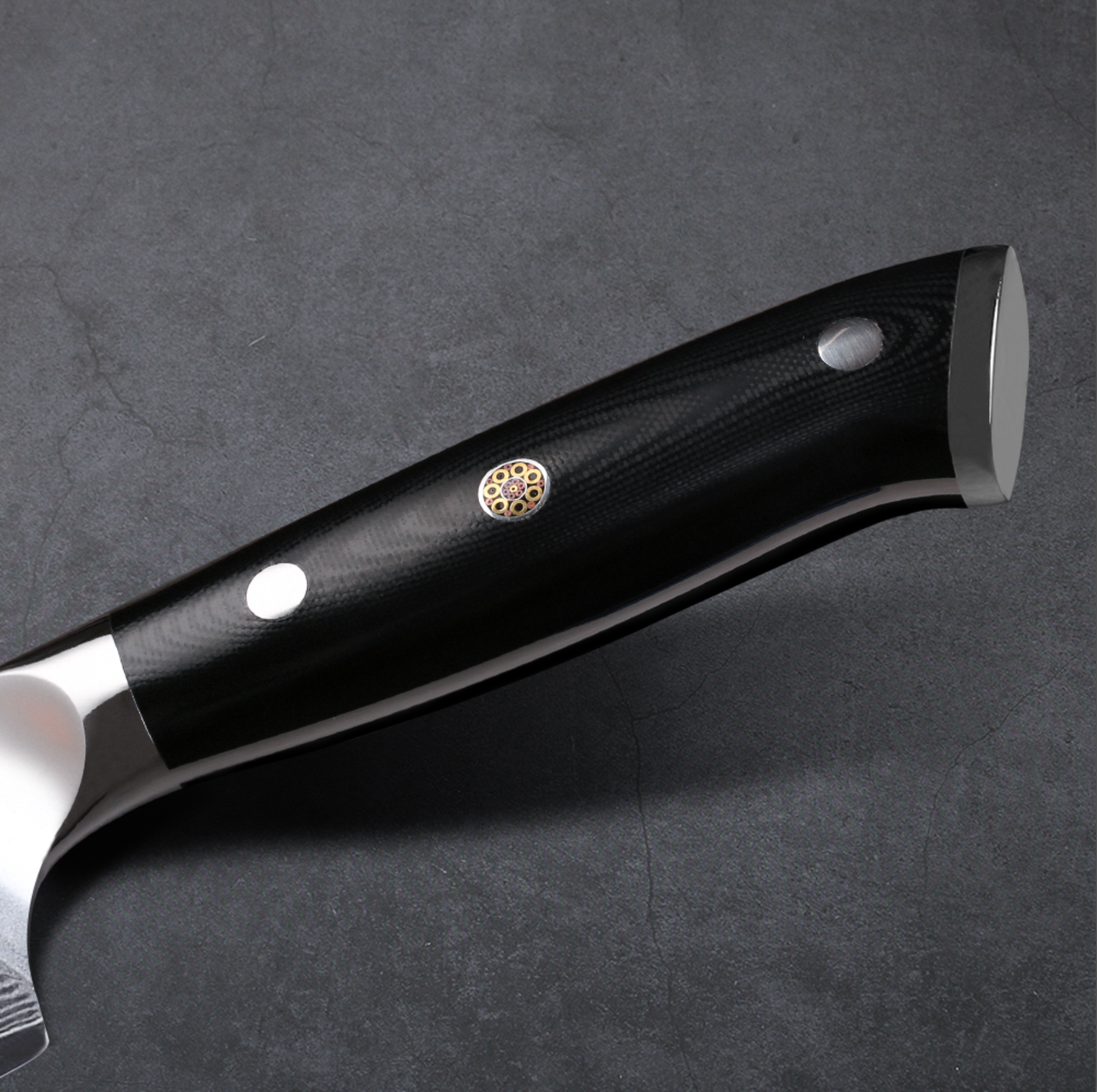 Image of Closeup of Pro Chefly black G10 triple-riveted handle on VG-10 Damascus serrated bread knife.